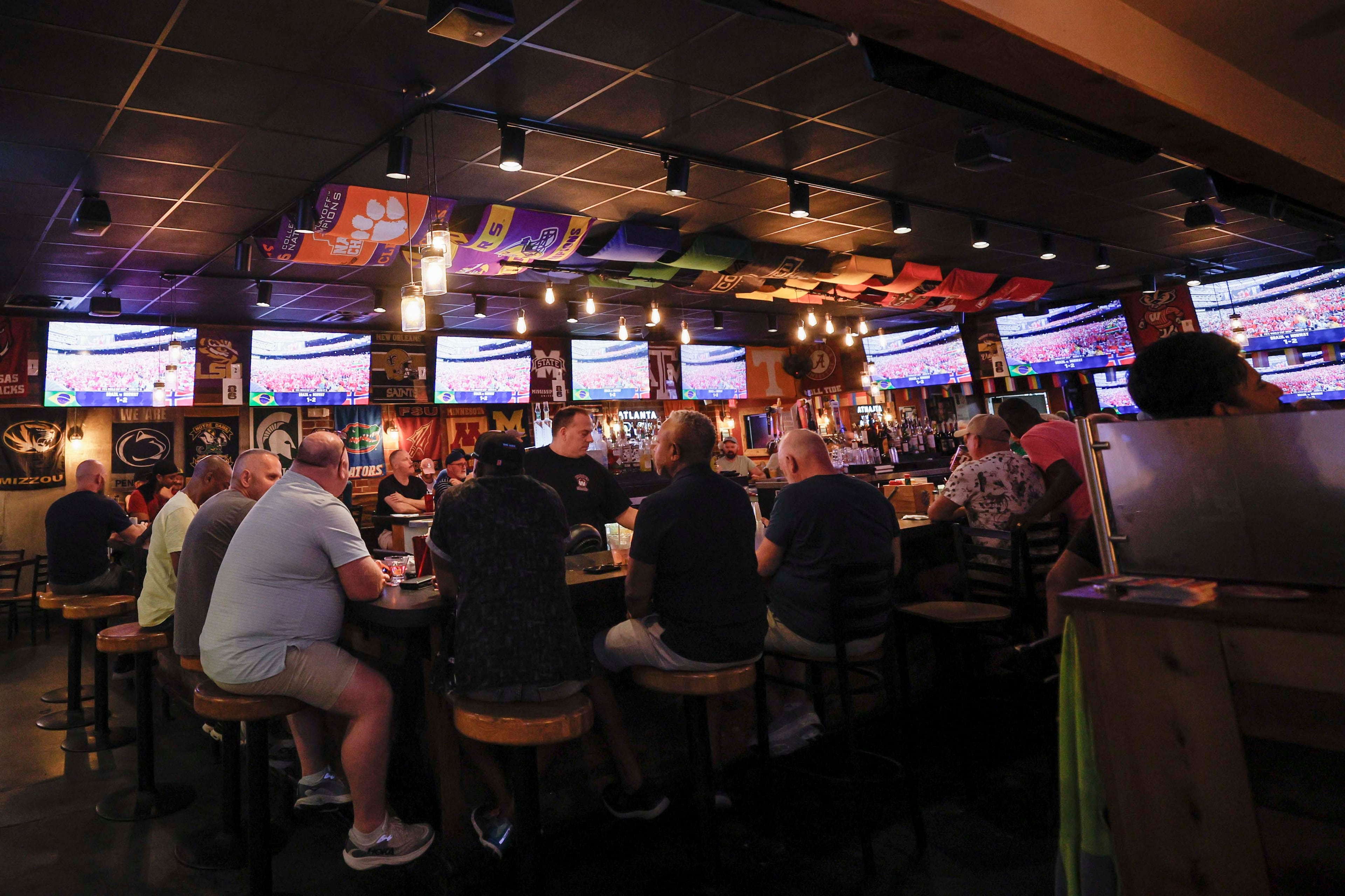 Woofs owner Gregory Hughes says the Pride House designation was “an honor.” And World Cup watch parties have helped boost sales at the bar. (Miguel Martinez/AJC)