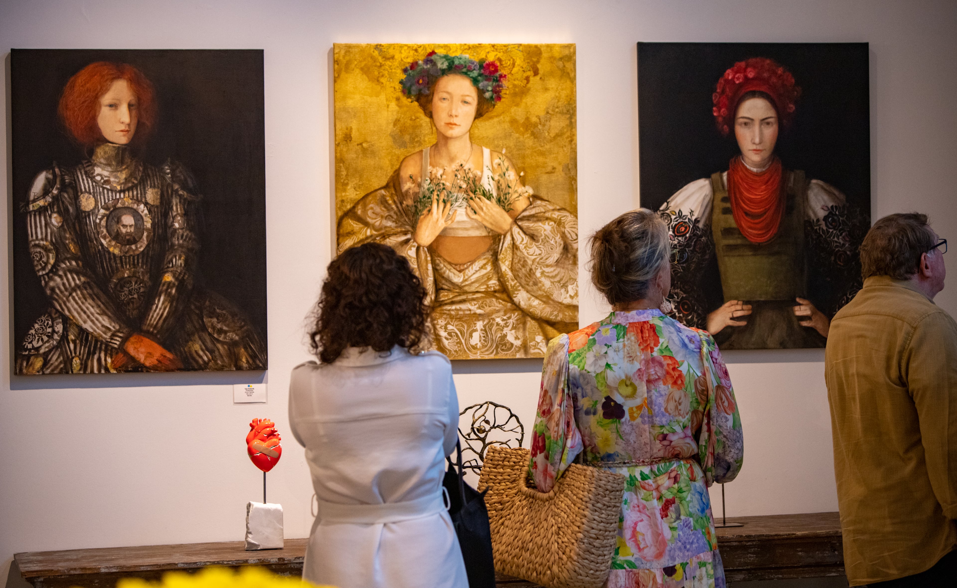 These three oil on canvas pieces are titled, “Protectress,” “Victory,” and “Ukraine.” (Jenni Girtman for The Atlanta Journal-Constitution)