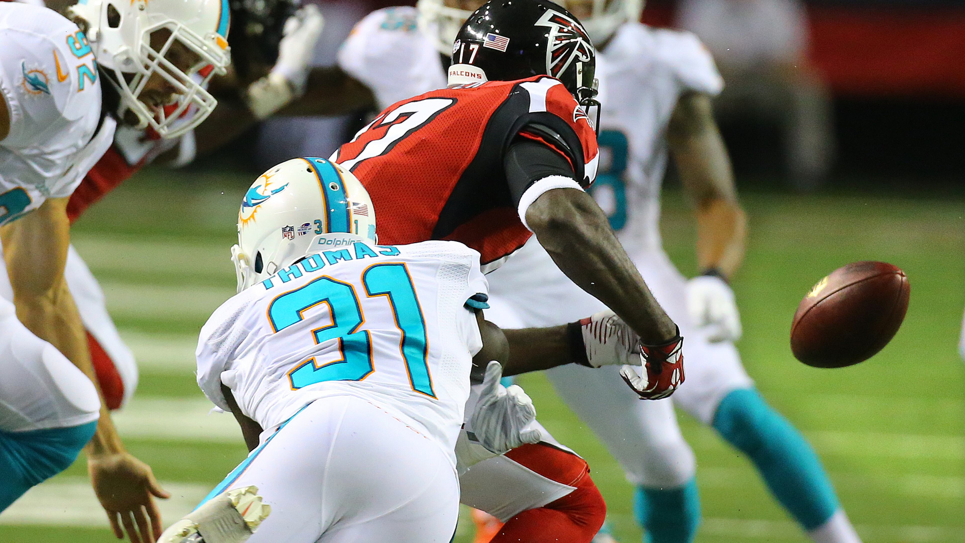 Falcons Devin Hester fumbles a punt return as he is hit by Miami safety Michael Thomas during their NFL exhibition game on Friday, August 8, 2014, in Atlanta. The play was negated by a penalty and fourth down was replayed.