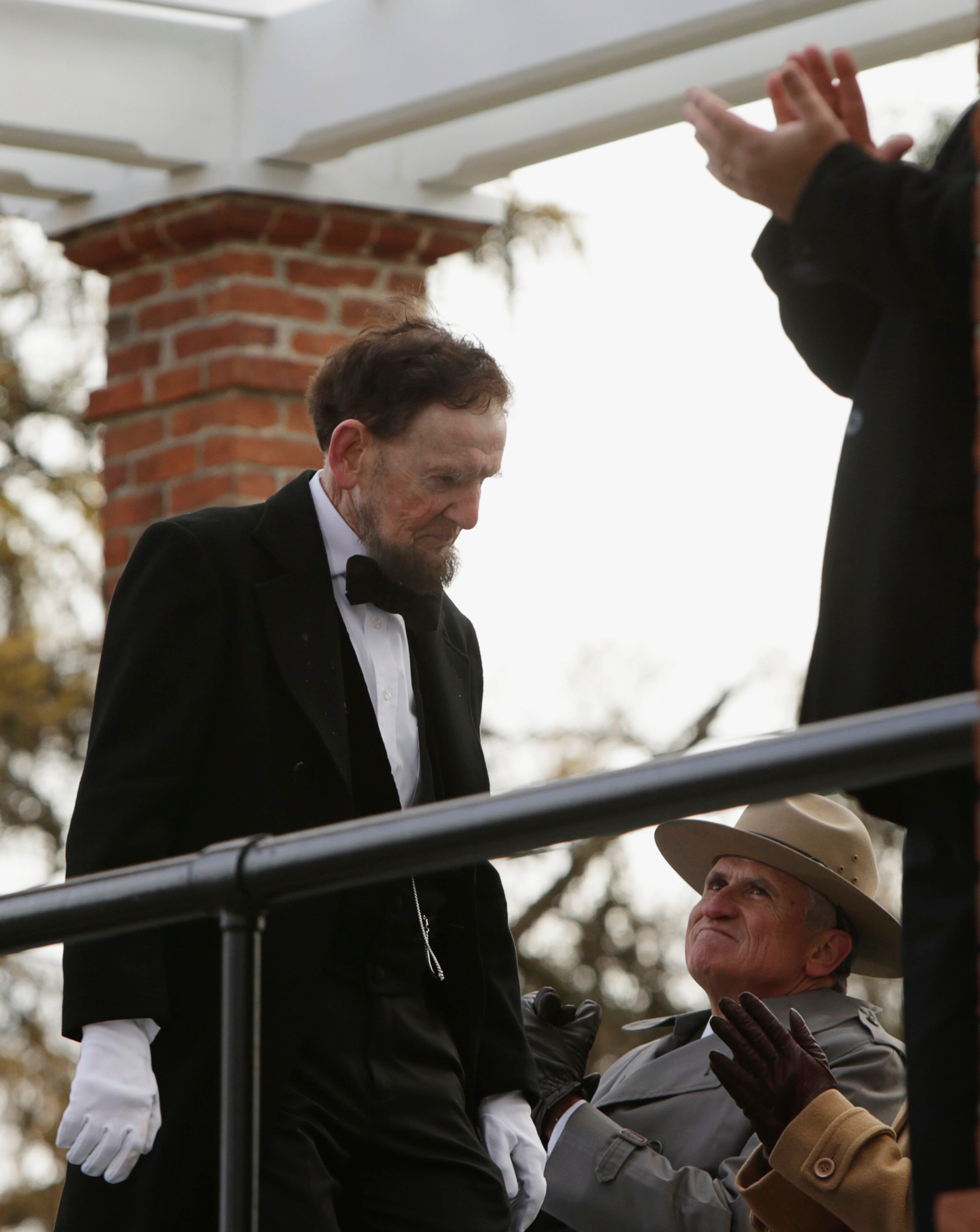 James Getty (L), portraying U.S. President Abraham Lincoln, is applauded after delivering the Gettysburg Address at the Gettysburg National Cemetery in Pennsylvania November 19, 2013. Lincoln travelled to Gettysburg in 1863 to deliver a few concluding remarks at a formal dedication. Today marks the 150th anniversary of Lincoln's famous two-minute speech. REUTERS/Gary Cameron