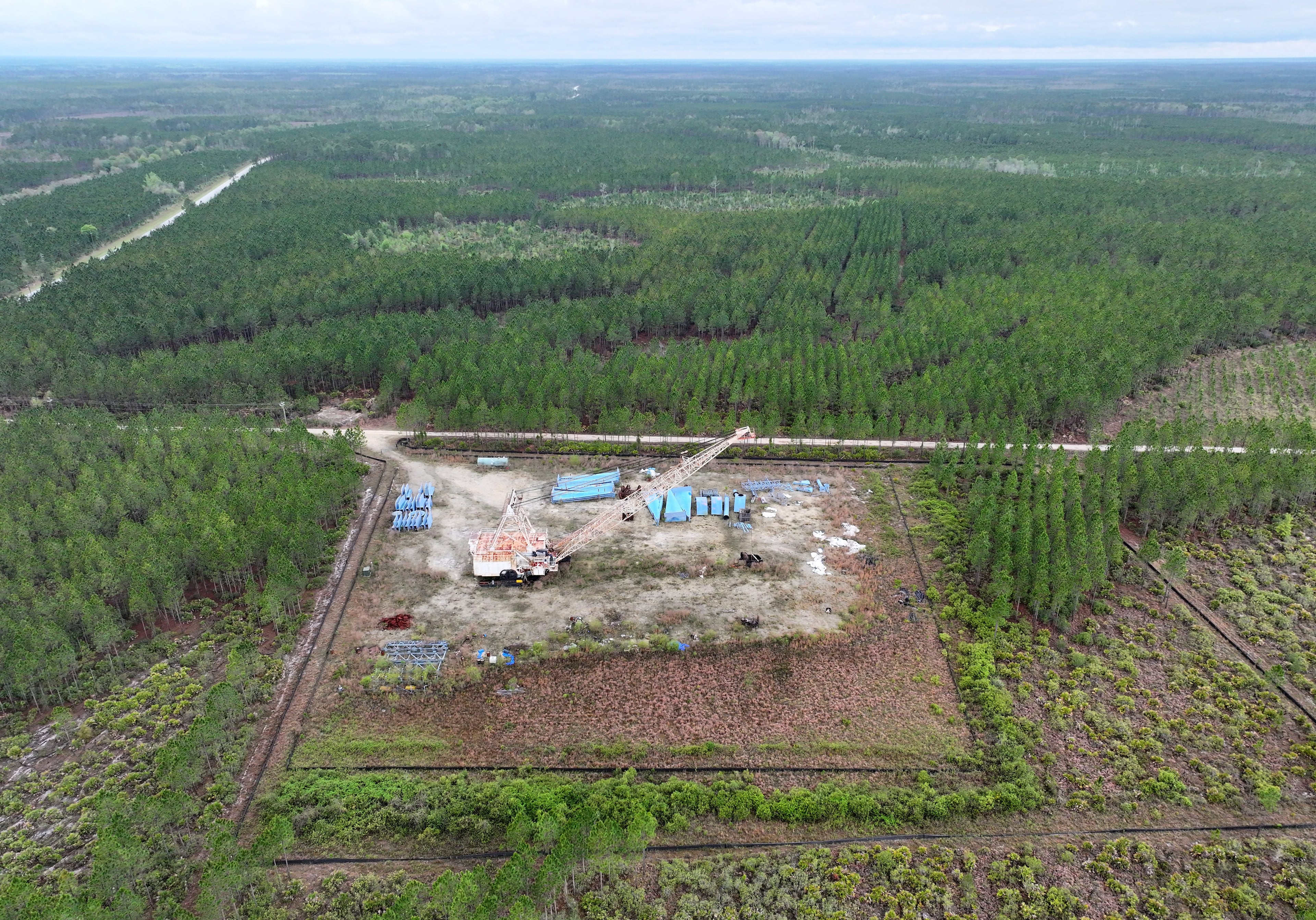 A drone photograph shows the Twin Pines mine site where equipment is stationed on Monday, March 18, 2024, in Charlton County. The site is located less than 3 miles from the Okefenokee National Wildlife Refuge, the largest U.S. refuge east of the Mississippi River. (Hyosub Shin/AJC)