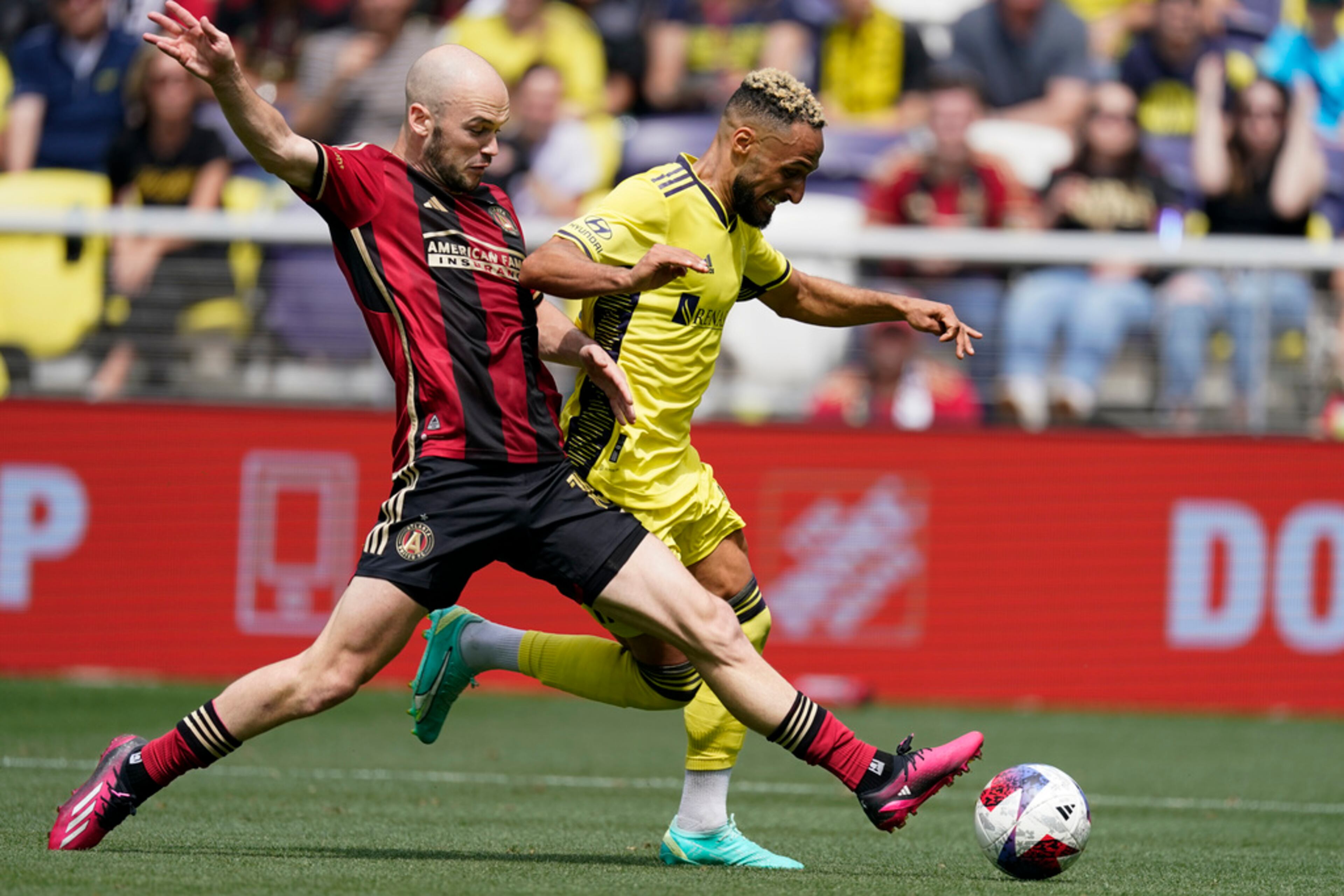 Atlanta United defender Andrew Gutman (15) tries to take the ball from Nashville SC midfielder Hany Mukhtar (10) during the second half of an MLS soccer match on Saturday, April 29, 2023, in Nashville, Tenn. Nashville SC won 3-1.(AP Photo/George Walker IV)