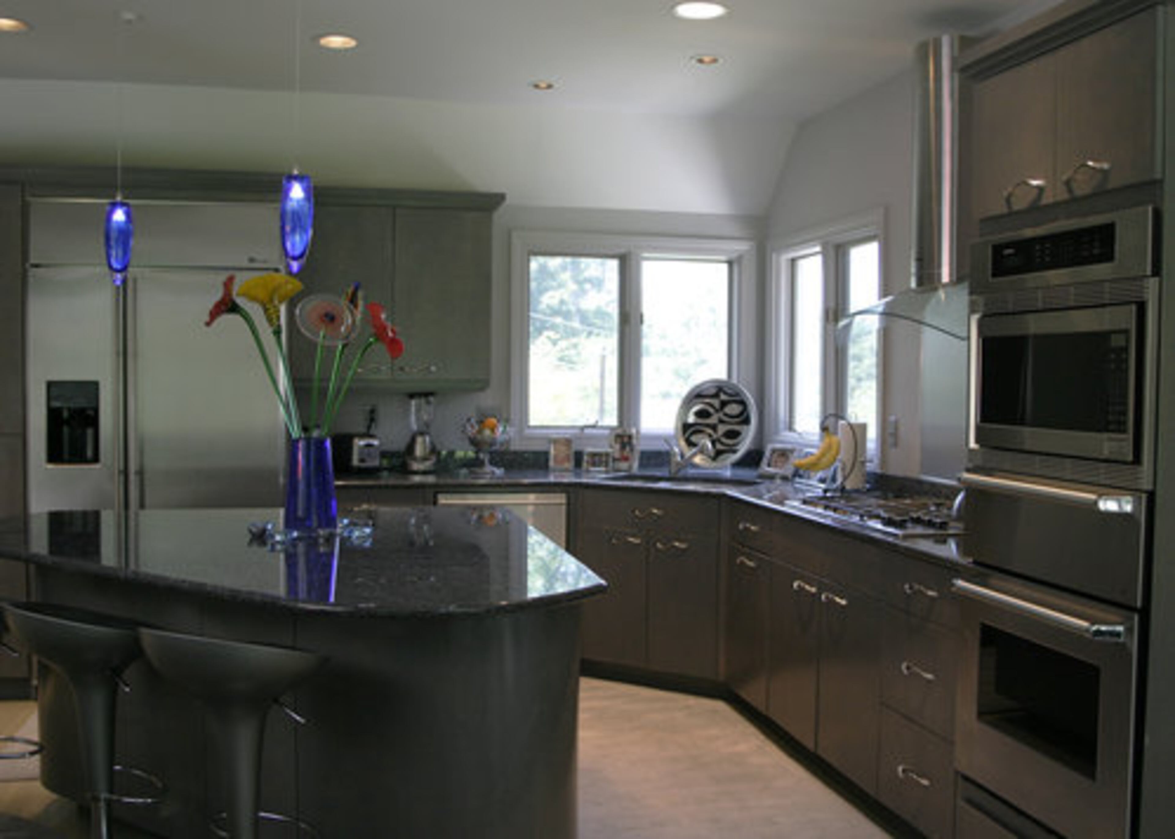 This is the family's favorite space for sharing quality time. The island needed to be big enough to serve double duty as a homework center. The couple completely gutted and renovated the kitchen in a straight line deco-style. They used a similar metallic overcoat on the cabinets. "It takes the flatness out and gives it a little life," Julie Huff said.