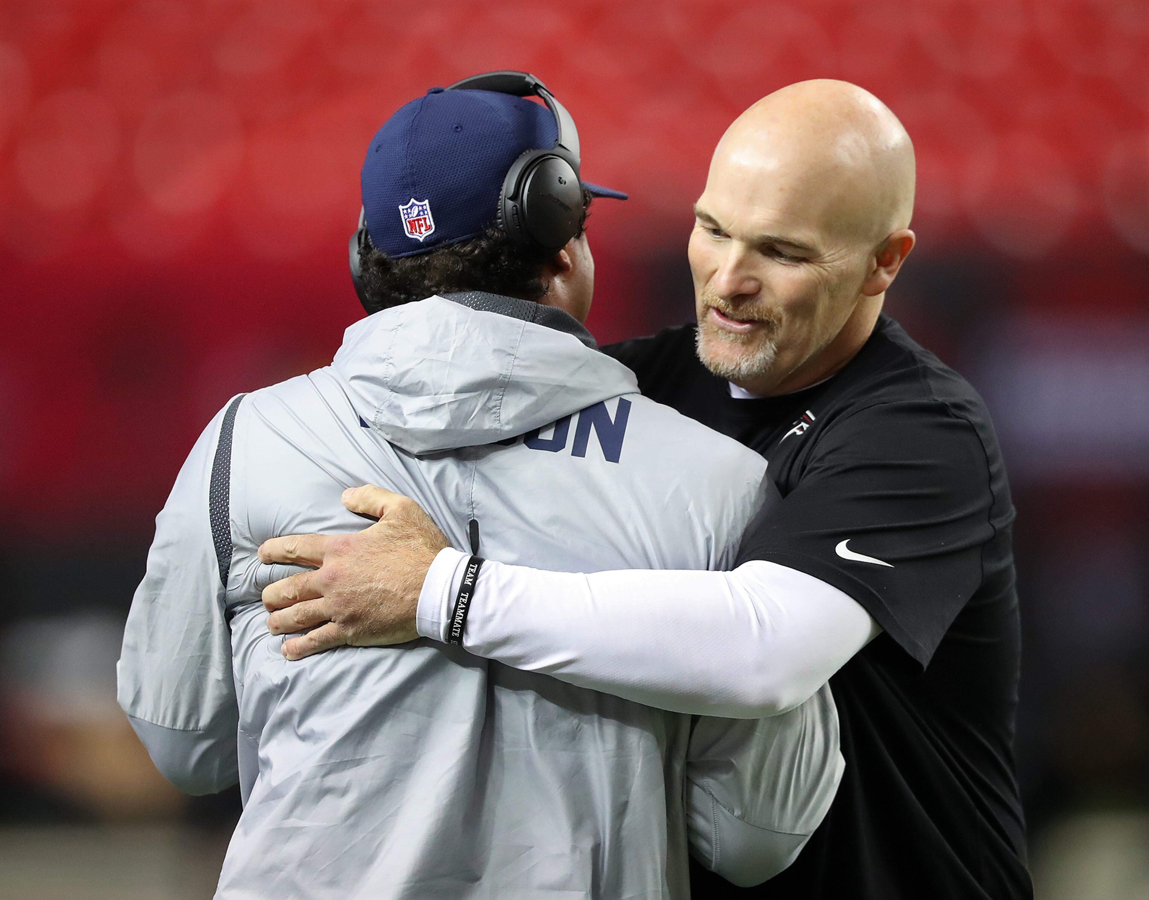 January 14, 2017, Atlanta: Falcons head coach Dan Quinn gives Seahawks quarterback Russell Wilson a hug while they greet each other before their NFL divisional playoff game on Saturday, Jan. 14, 2017, in Atlanta. Curtis Compton/ccompton@ajc.com