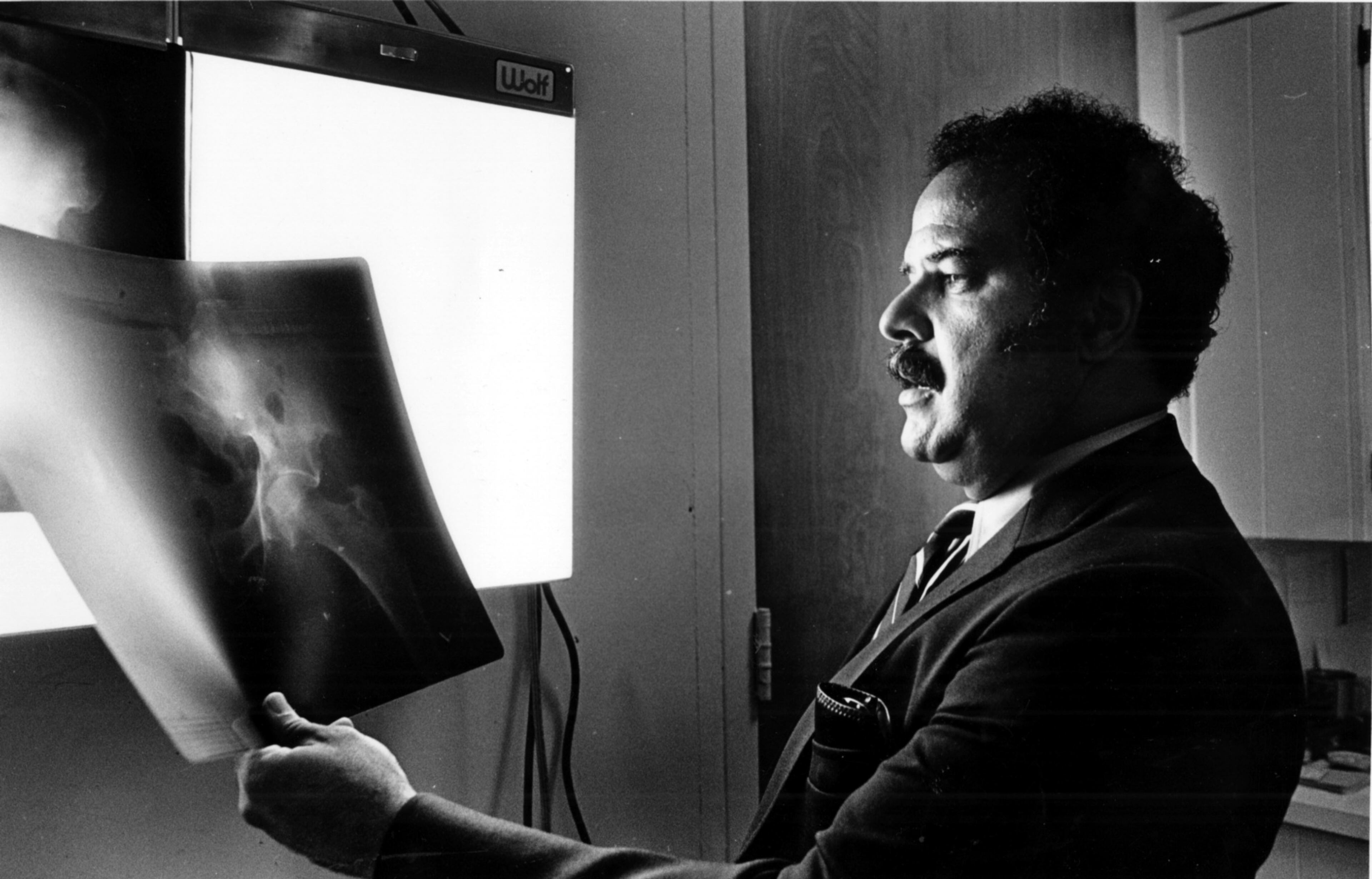 Dr. Hamilton E. Holmes was one of the first two black students to attend the University of Georgia. Here he is in his office with X-rays in August 1983.