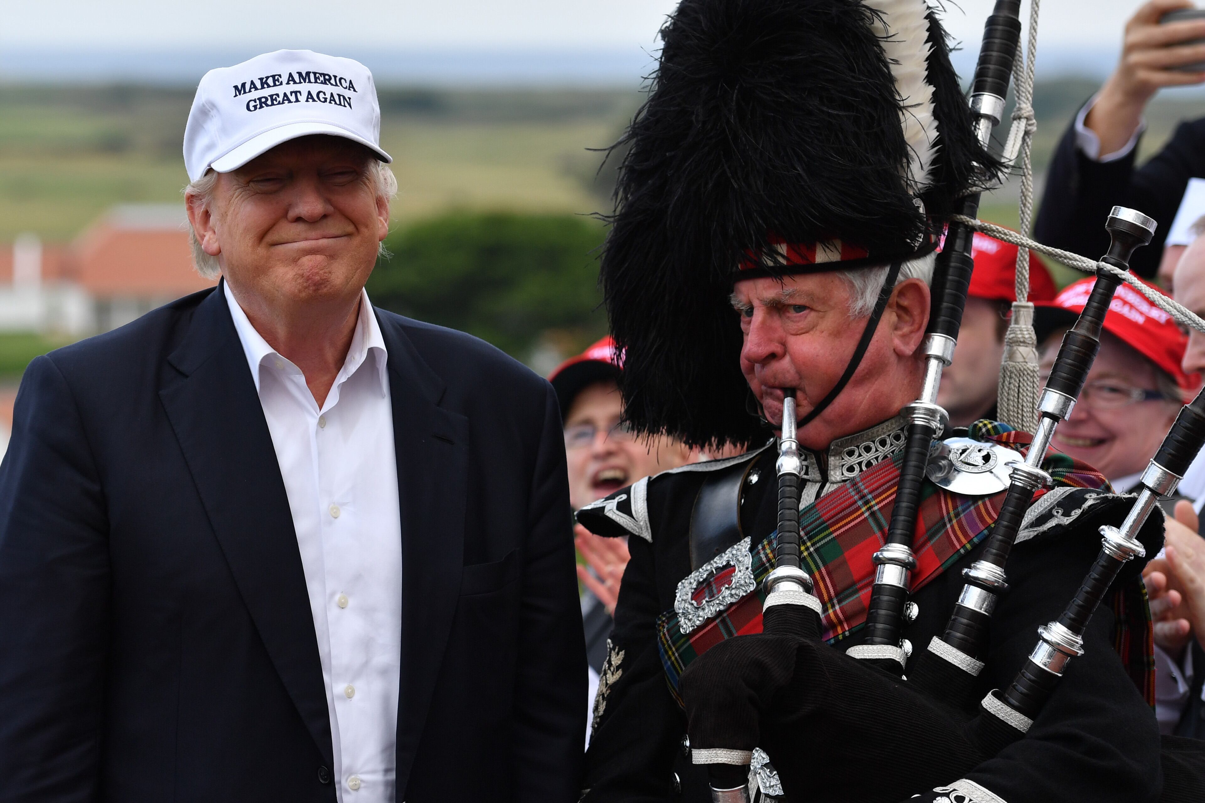 A bagpipe player wears traditional dress next to Presumptive Republican nominee for US president Donald Trump as he arrives to his Trump Turnberry Resort on June 24, 2016 in Ayr, Scotland. Mr Trump arrived to officially open his golf resort which has undergone an eight month refurbishment as part of an investment thought to be worth in the region of two hundred million pounds. (Photo by Jeff J Mitchell/Getty Images)