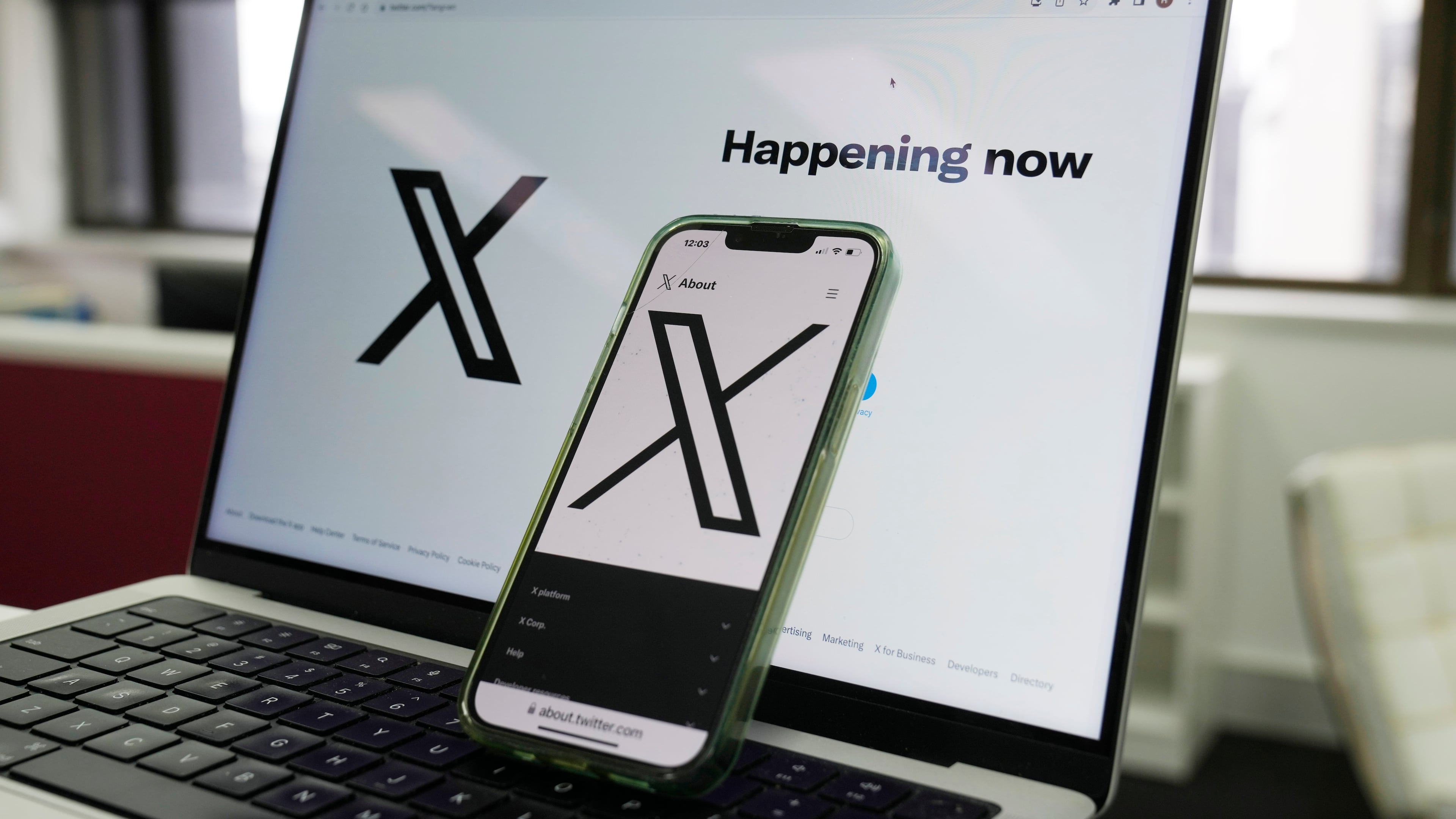 FILE - The opening page of X is displayed on a computer and phone, Oct. 16, 2023, in Sydney. (AP Photo/Rick Rycroft, File)