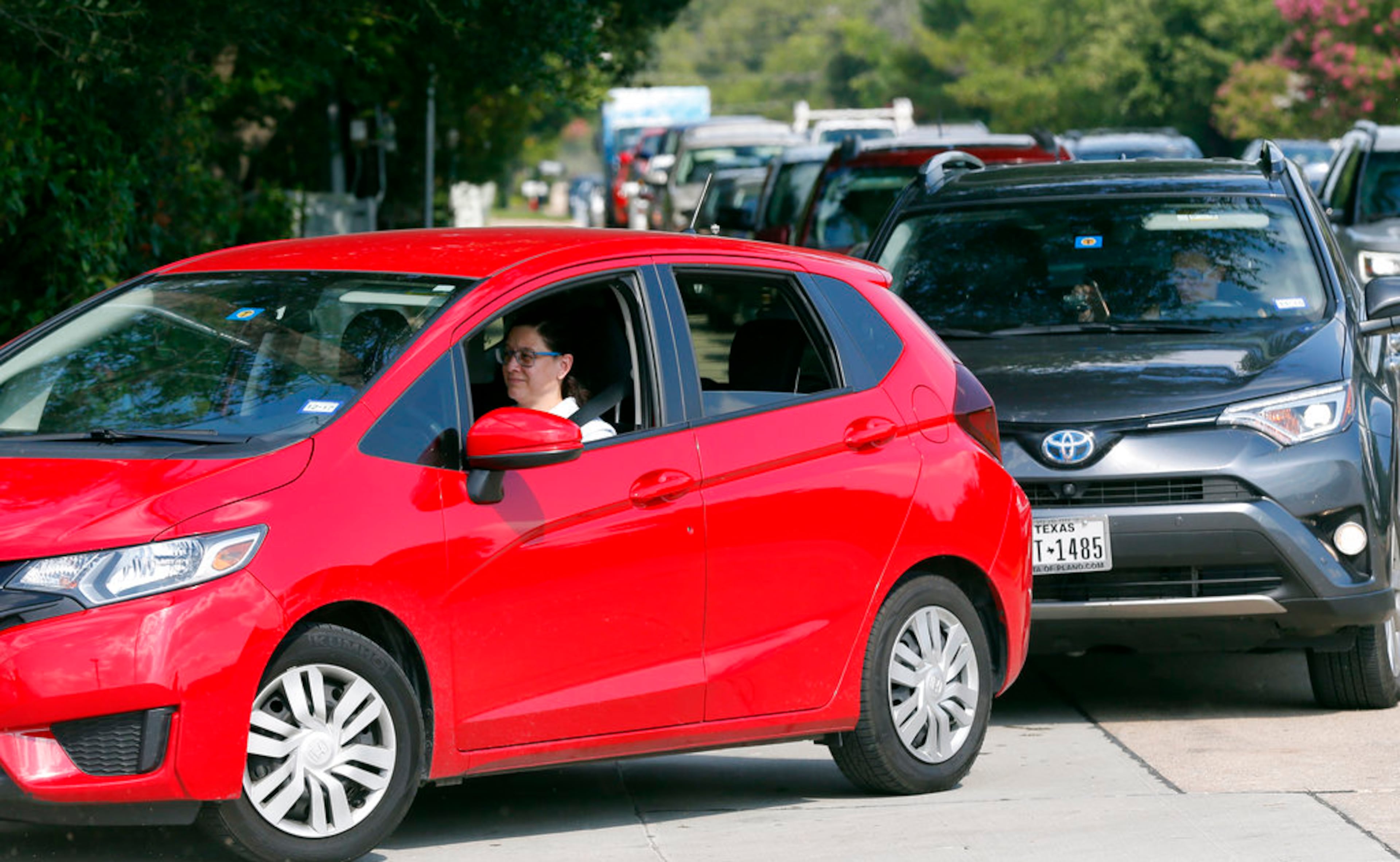 Customers line up along a busy thoroughfare to get into a QT filling station and convenience store, Thursday, Aug. 31, 2017, in Dallas. It's getting harder to fill gas tanks in parts of Texas where some stations are out of fuel and pump costs are spiking. A major gasoline pipeline shuttered due to Harvey may be able to resume shipping fuel from the Houston area by Sunday, which could ease gasoline shortages across the southern U.S.