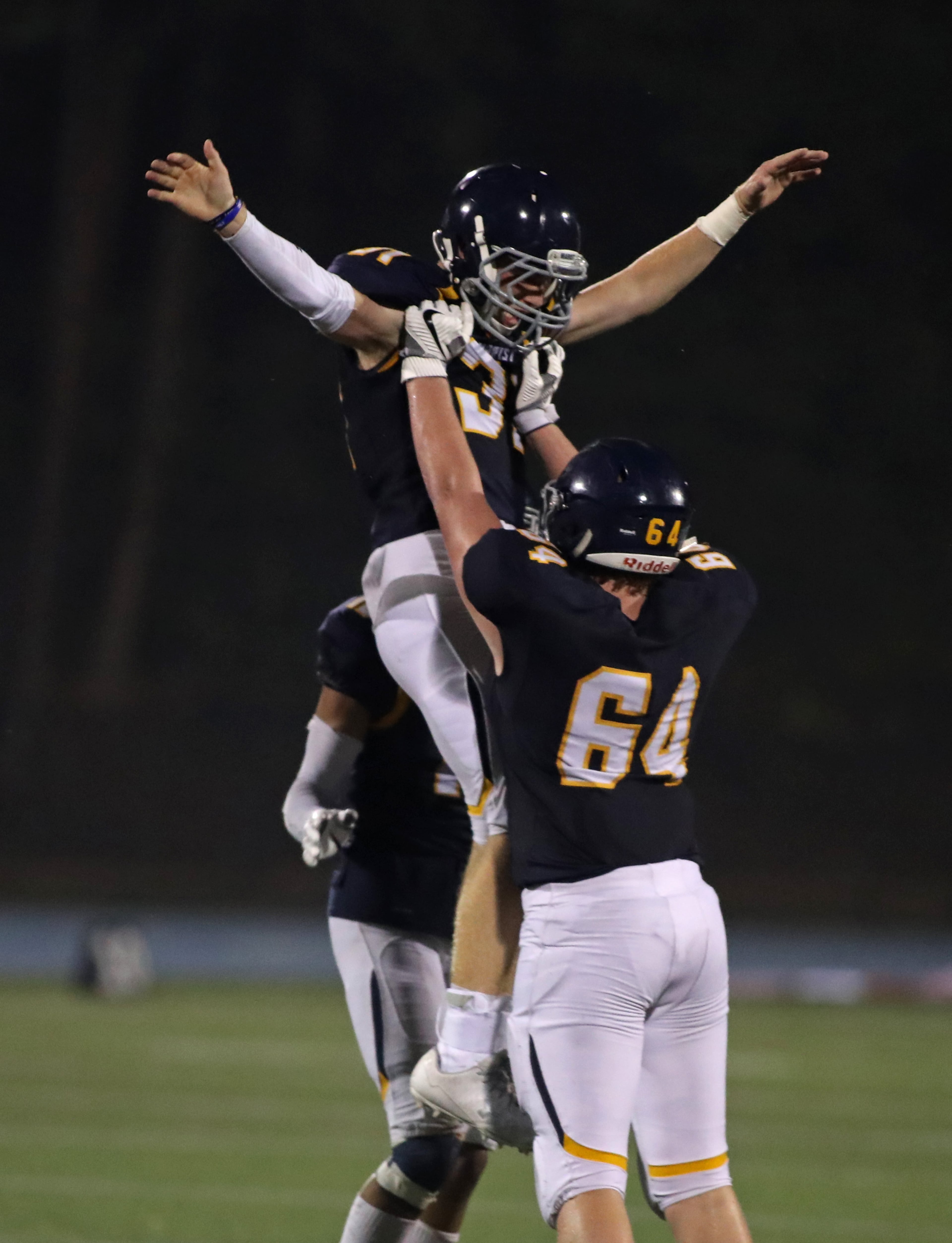 Marist defensive back Eric Boyd (31) celebrates an interception with defensive lineman Dean Colton (64) in the second half against Woodward Academy at Marist Friday, September 15, 2017, in Atlanta. Marist won 34-17. PHOTO / JASON GETZ