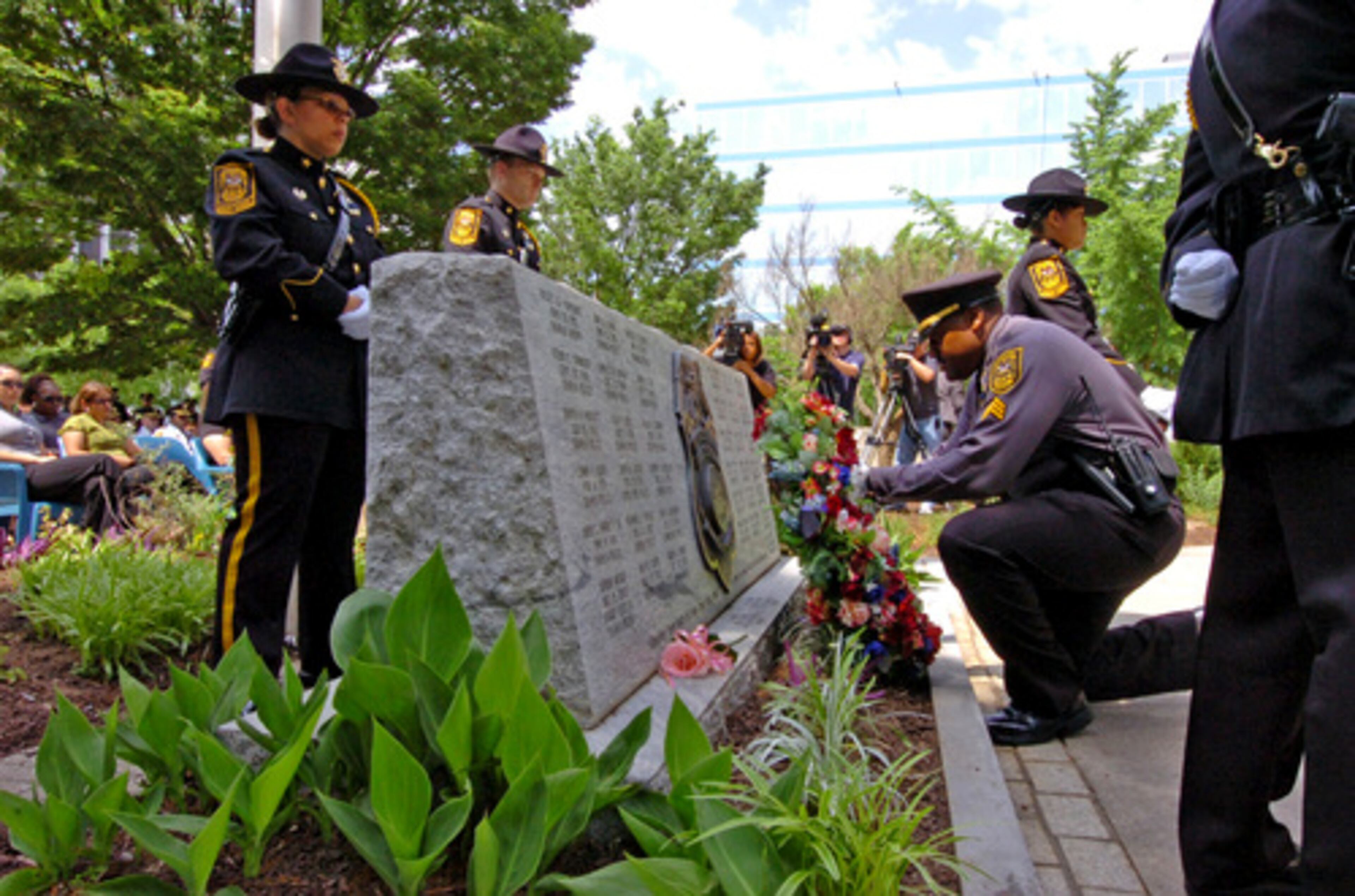 Sgt C.D. Swain places a wreath on the memorial for Fallen DeKalb Police Officers during the annual ceremony. Also in photo are Sgt N. Rutland (left back), Master Police Officer W. Franklyn (right back) and Officer M. L. Ellis (right).