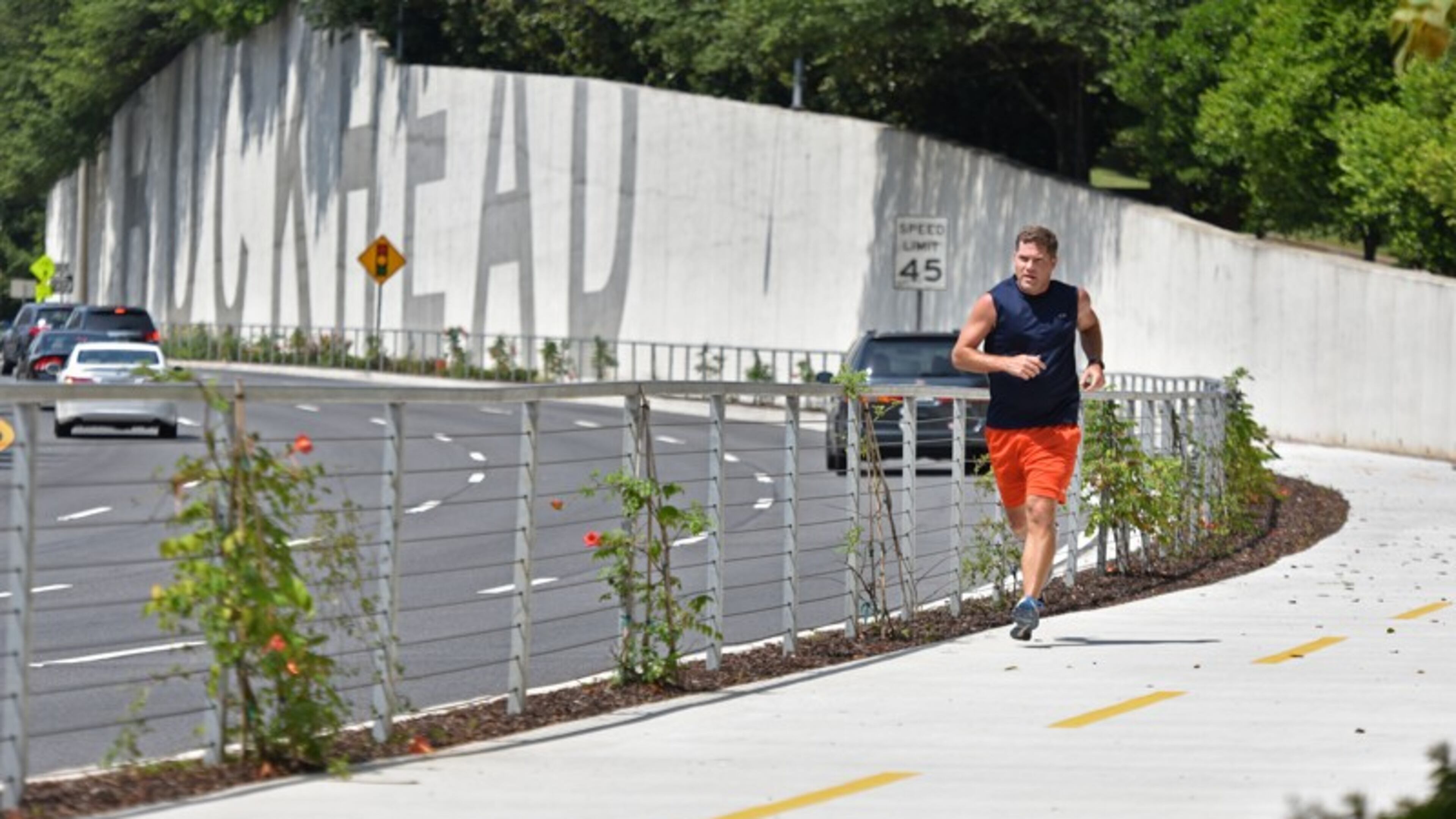 Nick Huston, of Sandy Springs, jogs on the Phase 1 stretch of PATH400 along Ga. 400 in Buckhead. Roswell supports a trail in the Ga. 400 corridor extending south to a possible link-up with PATH400 in Sandy Springs. HYOSUB SHIN / HSHIN@AJC.COM