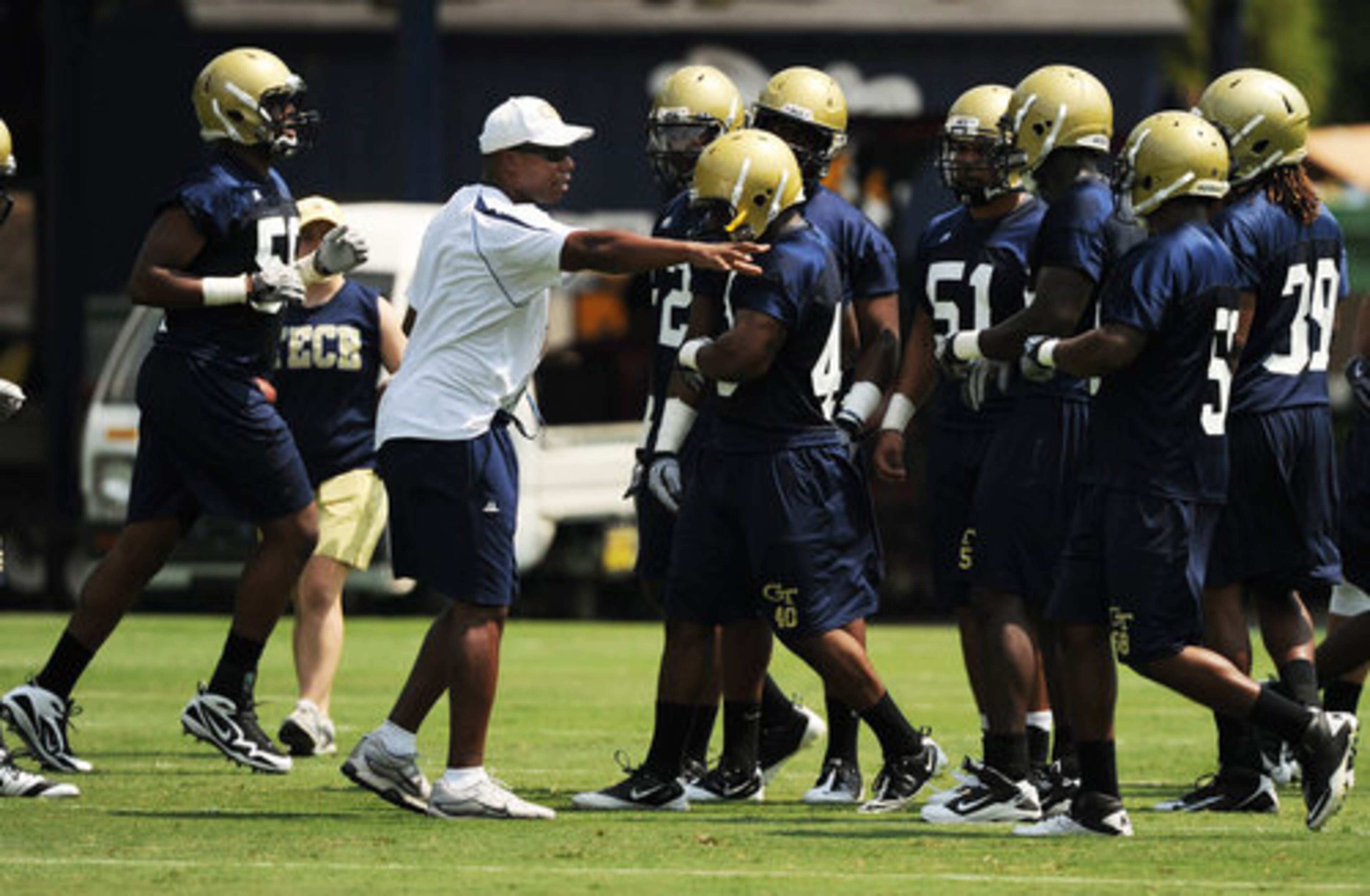 Linebackers coach Joe Speed works with his players Wednesday. The Jackets defense allowed 23.7 points a game last season.