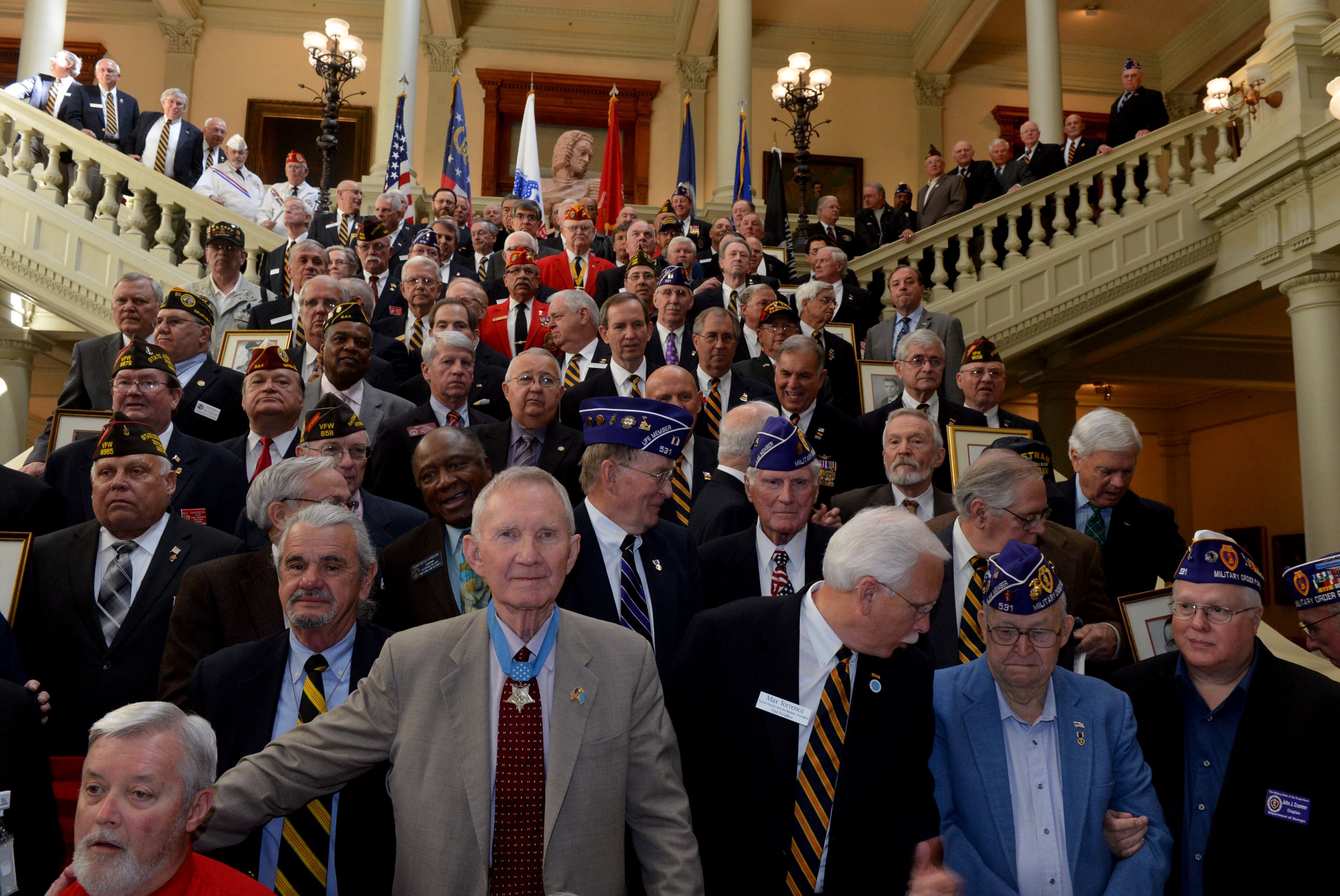 Medal of Honor recipient Major General James Livingston, USMC (Ret.) (center front) is surrounded by other veterans on the steps as they take a group photo. Veterans, family members and state officials attend a ceremony honoring Medal of Honor recipients from the Vietnam War at the Georgia Capitol Tuesday, March 25, 2014. Twelve Georgians, veterans of the Vietnam War, possess the Medal of Honor. It is the highest accolade this nation gives its warriors. On Tuesday, they were recognized in a special ceremony at the Capitol. Gov. Nathan Deal proclaimed March 29 as Vietnam Veterans Day in Georgia. KENT D. JOHNSON / KDJOHNSON@AJC.COM