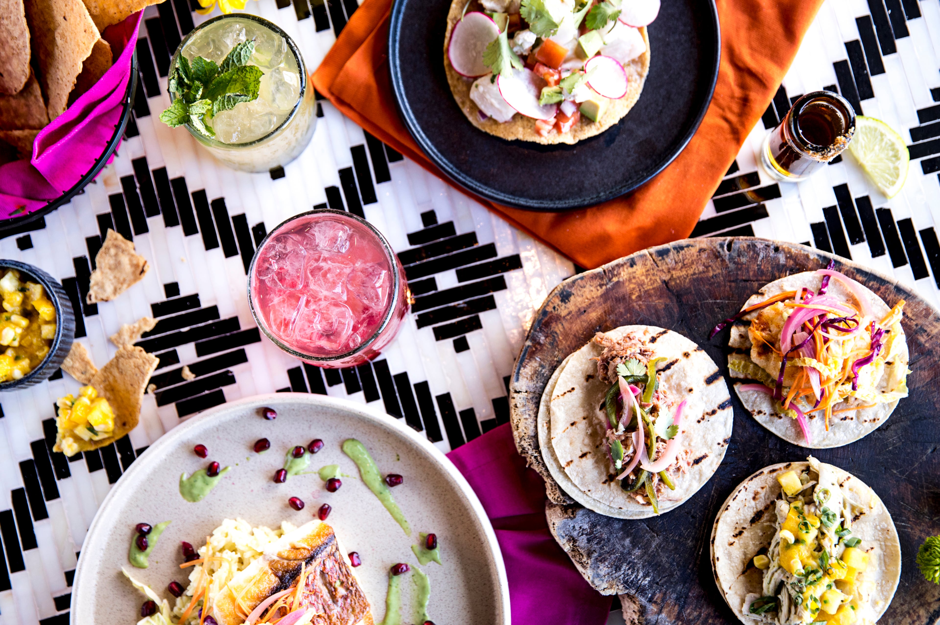 A tableful of food and cocktails from Chido + Padre's. (Courtesy of Heidi Geldhauser)