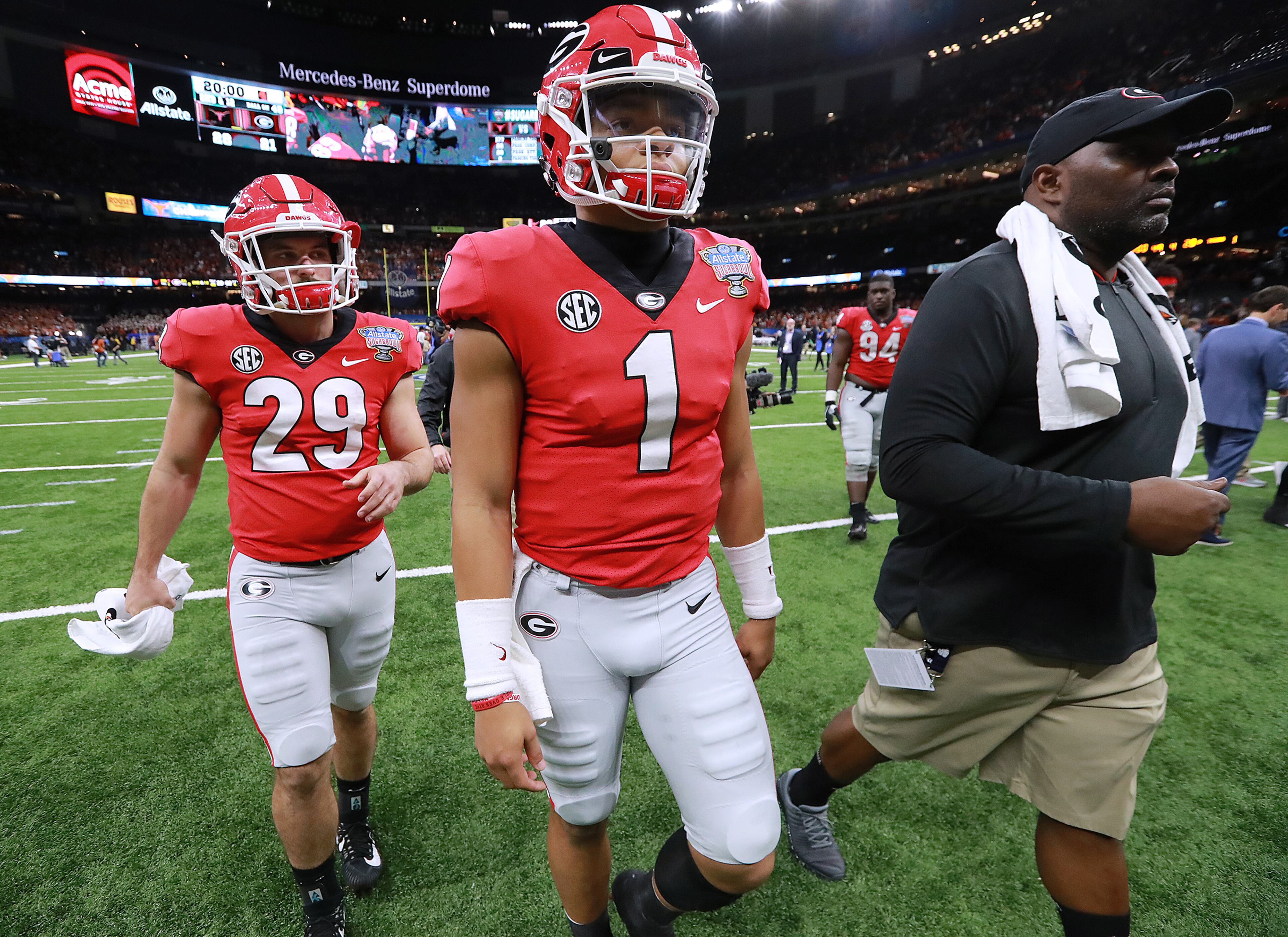 Jan. 01, 2019 New Orleans: Georgia quarterback Justin Fields walks off the field in what could be his final game with the Bulldogs after a 28-21 loss to Texas in the Allstate Sugar Bowl at Mercedes-Benz Superdome on Tuesday, Jan. 1, 2019, in New Orleans. Fields, who did not play in the game, is considering a transfer. Curtis Compton/ccompton@ajc.com