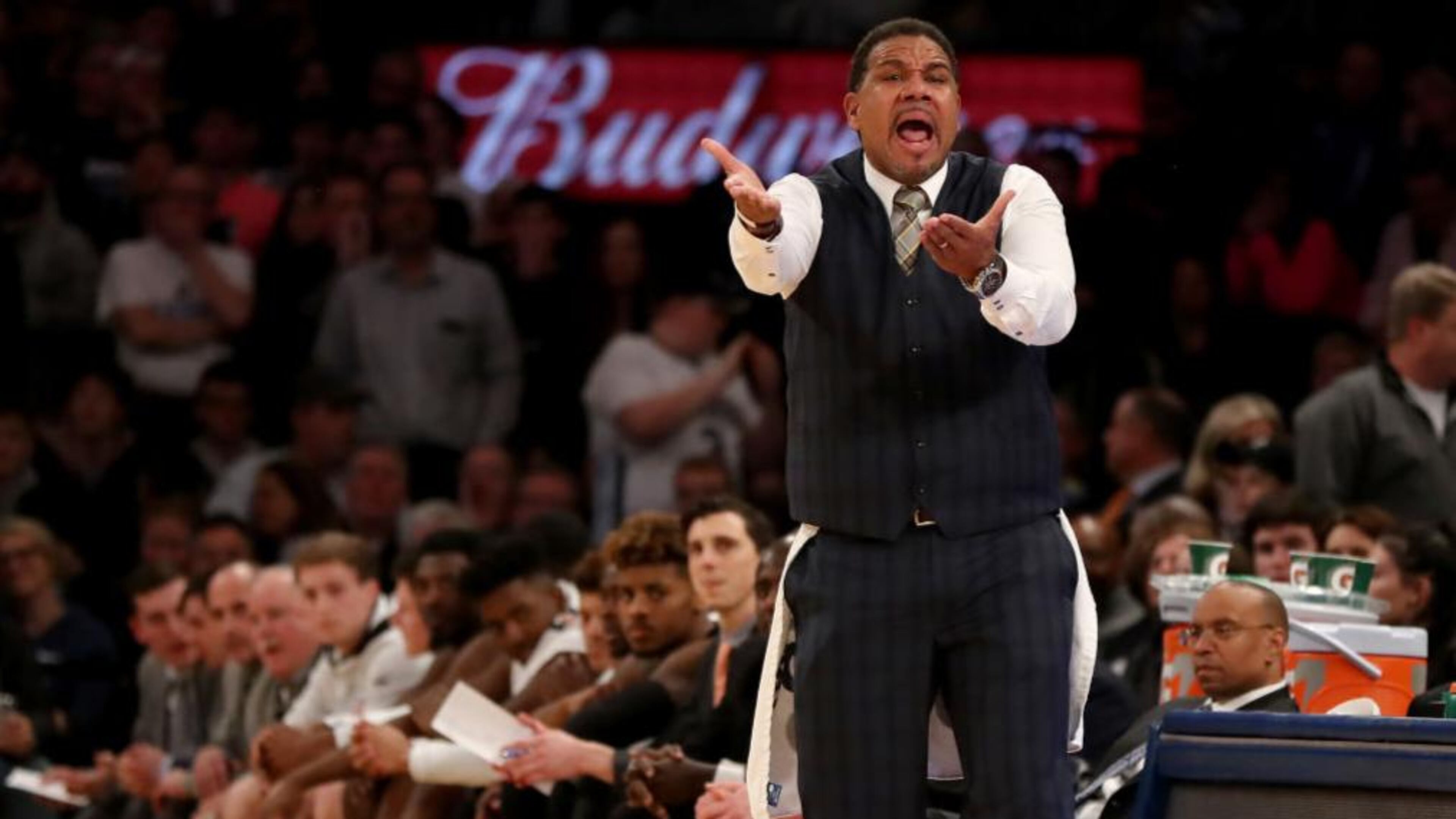 Providence basketball coach Ed Cooley wears a towel as he shouts instructions to his players during overtime Saturday at the Big East tournament.