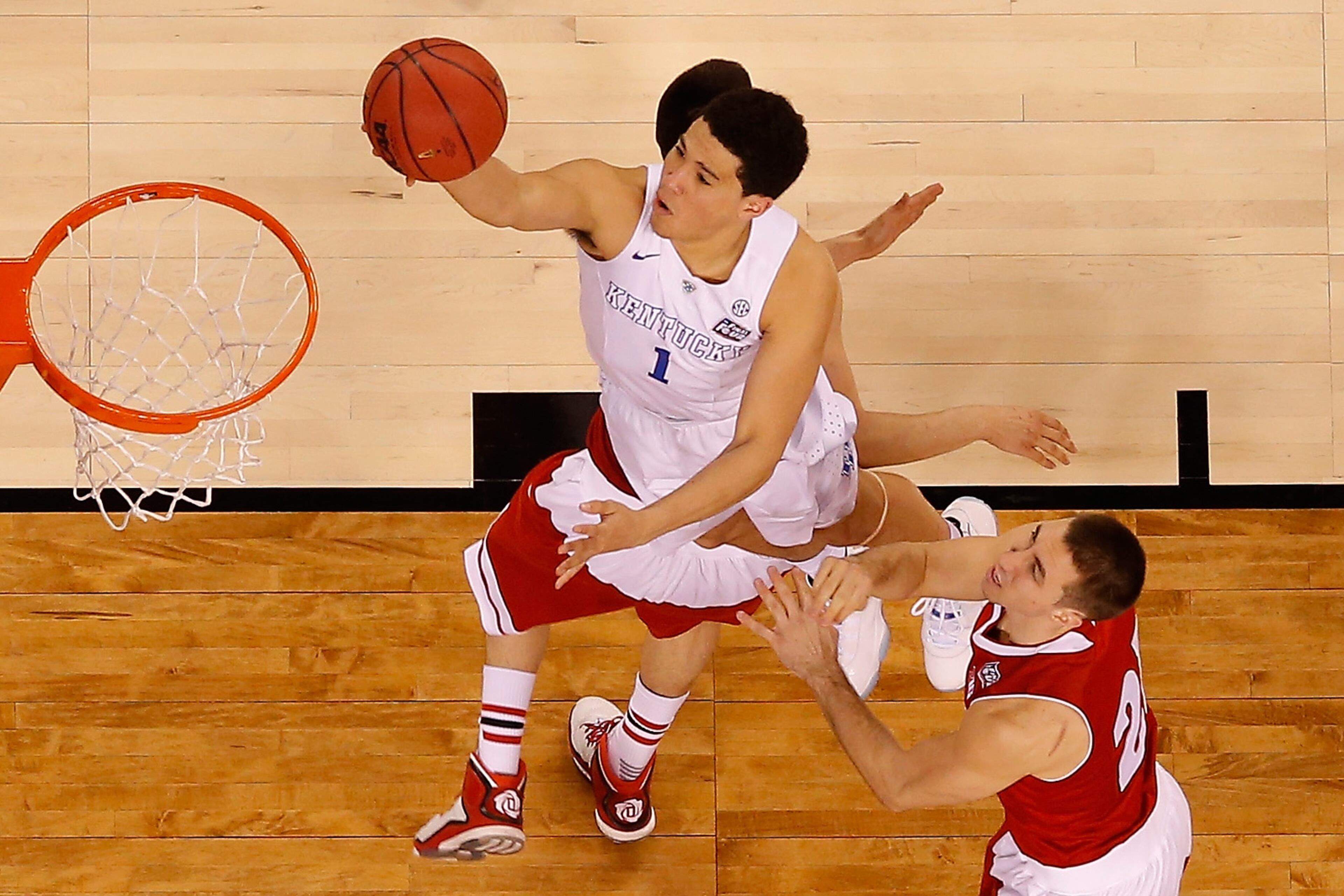 INDIANAPOLIS, IN - APRIL 04: Devin Booker #1 of the Kentucky Wildcats drives to the basket against Josh Gasser #21 of the Wisconsin Badgers in the second half during the NCAA Men's Final Four Semifinal at Lucas Oil Stadium on April 4, 2015 in Indianapolis, Indiana. (Photo by Andy Lyons/Getty Images)