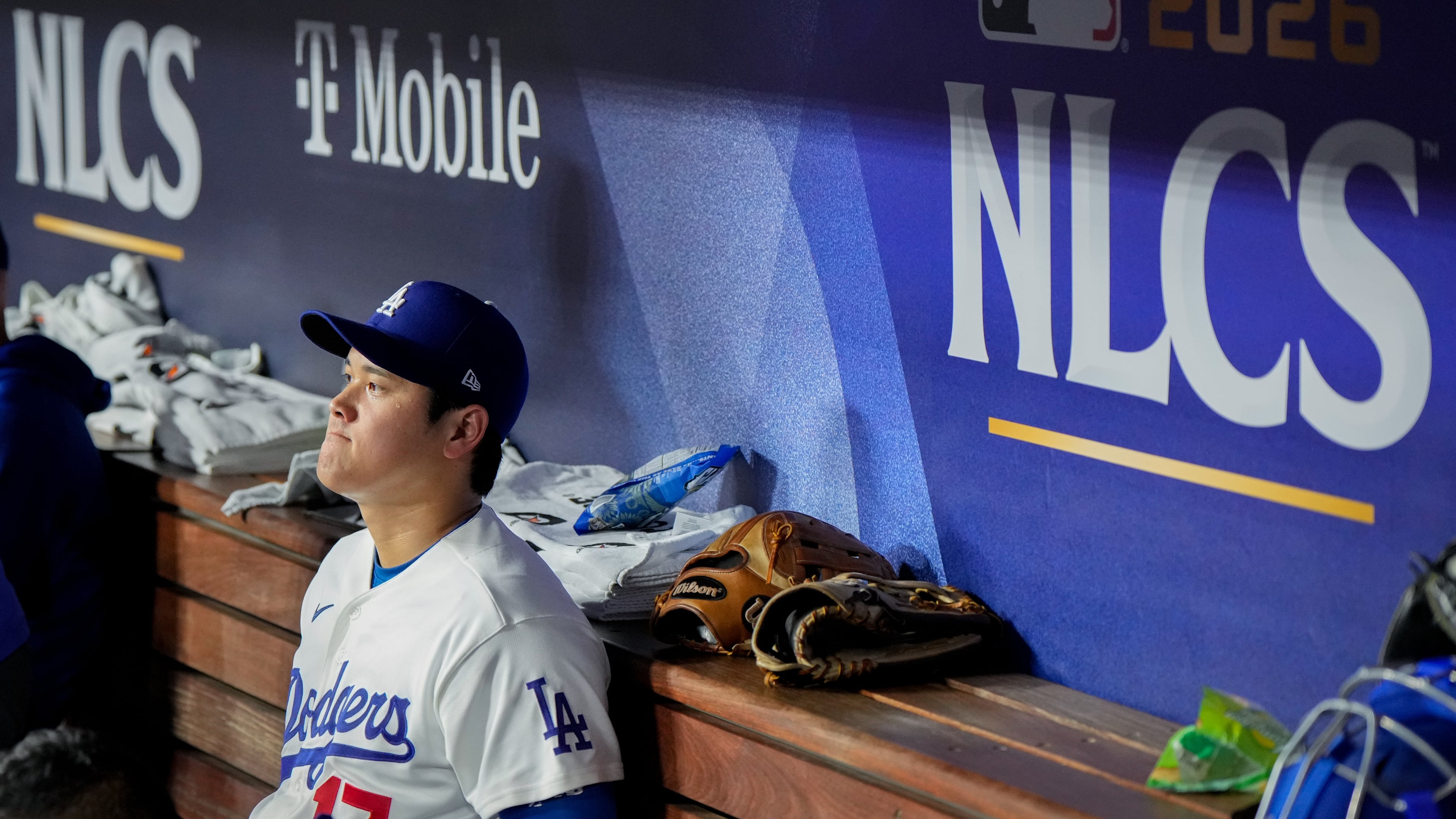 Los Angeles Dodgers designated hitter Shohei Ohtani sits in the dugout during the ninth inning of Game 3 of baseball's National League Championship Series between the Milwaukee Brewers and the Los Angeles Dodgers, Wednesday, Oct. 14, 2026, in Los Angeles. (AP Photo/Ashley Landis)