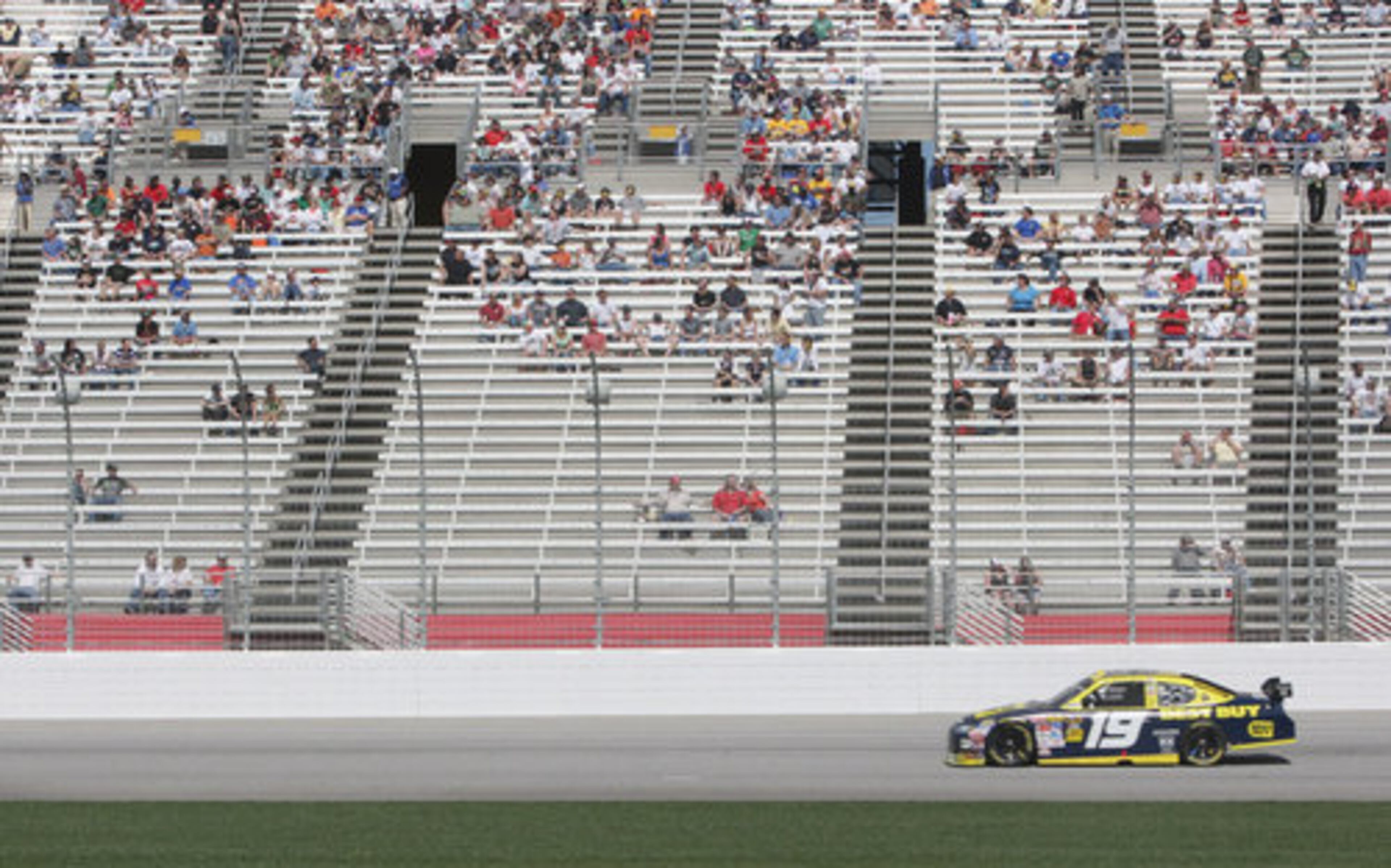 Elliot Sadler races past a nearly empty grandstand during Sunday's Kobalt Tools 500 at Atlanta Motor Speedway.