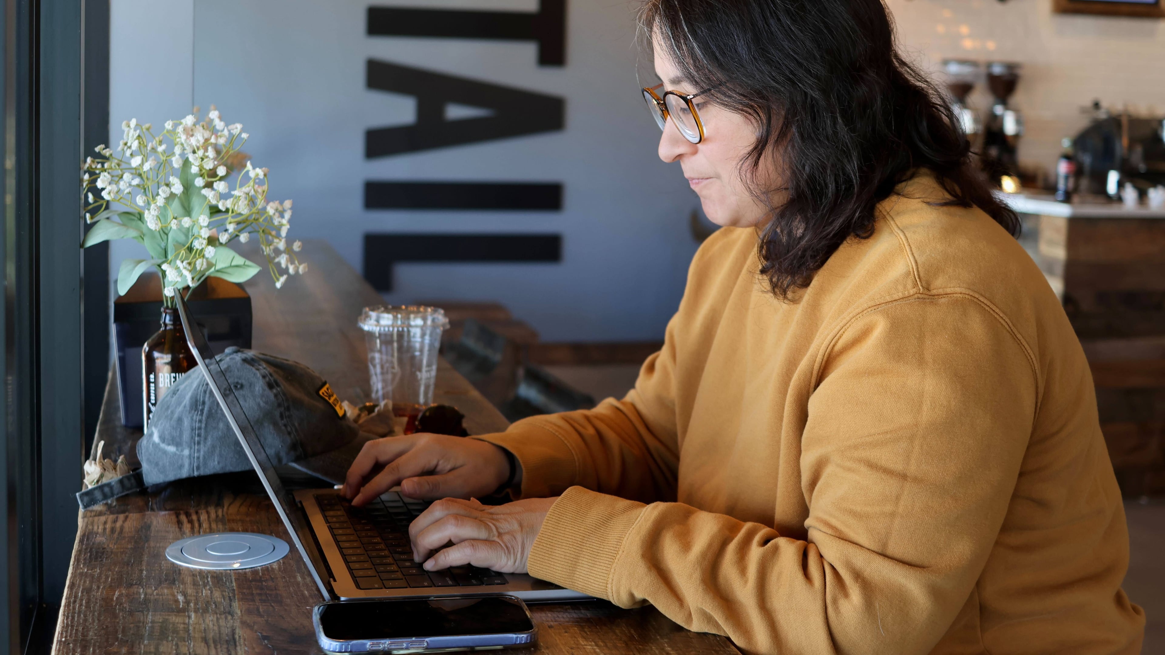Lauren Contreras, 40, works from her laptop at Foxtail Coffee Co., in Flagstaff, Ariz., on Monday, April 20, 2026. (AP Photo/Cheyanne Mumphrey)