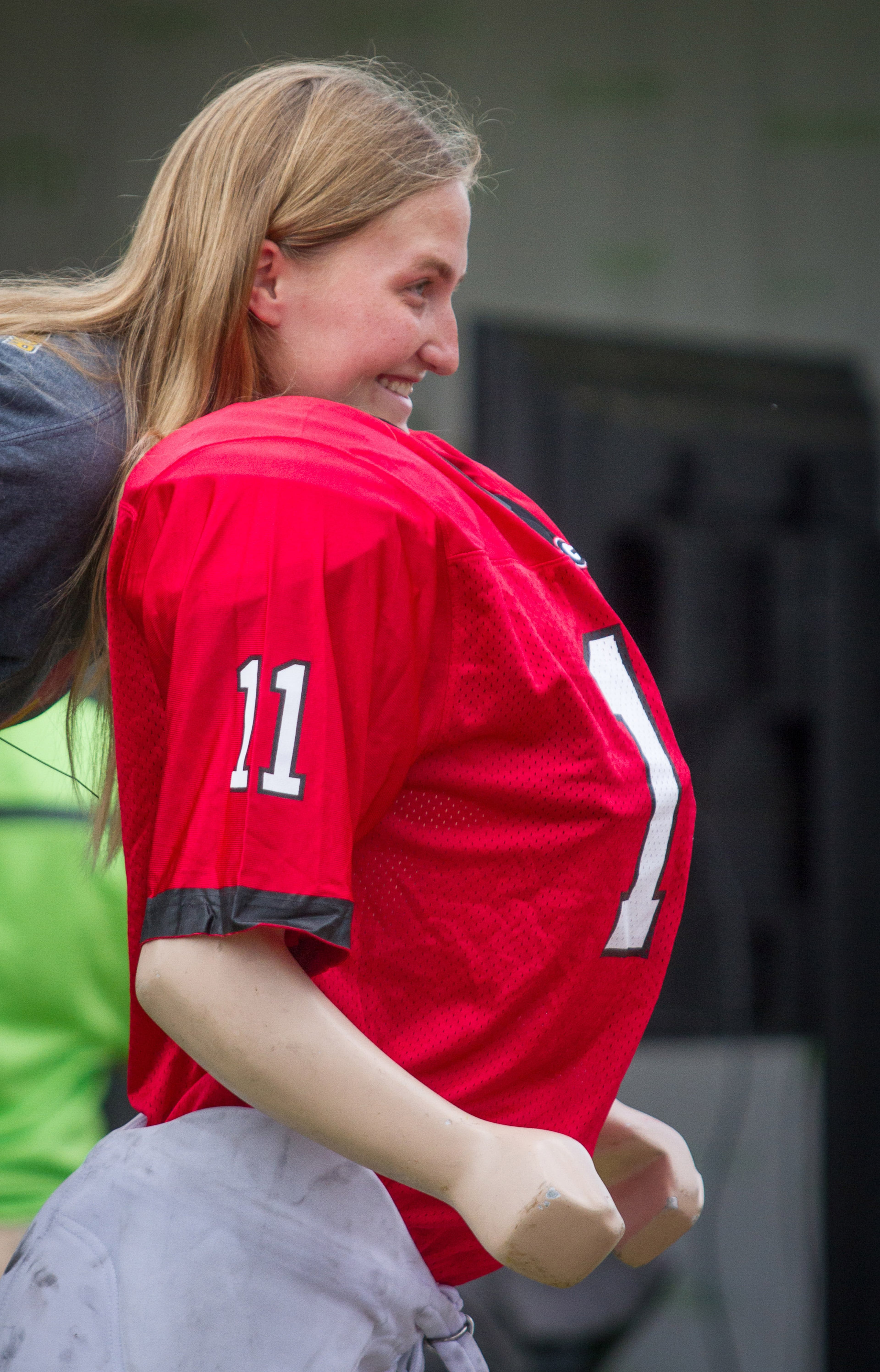 Anna Roberts poses for a photo with a large mannequin in a football uniform during the Inaugural SEC Summerfest in Centennial Olympic Park Sunday, July 15, 2018. STEVE SCHAEFER / SPECIAL TO THE AJC