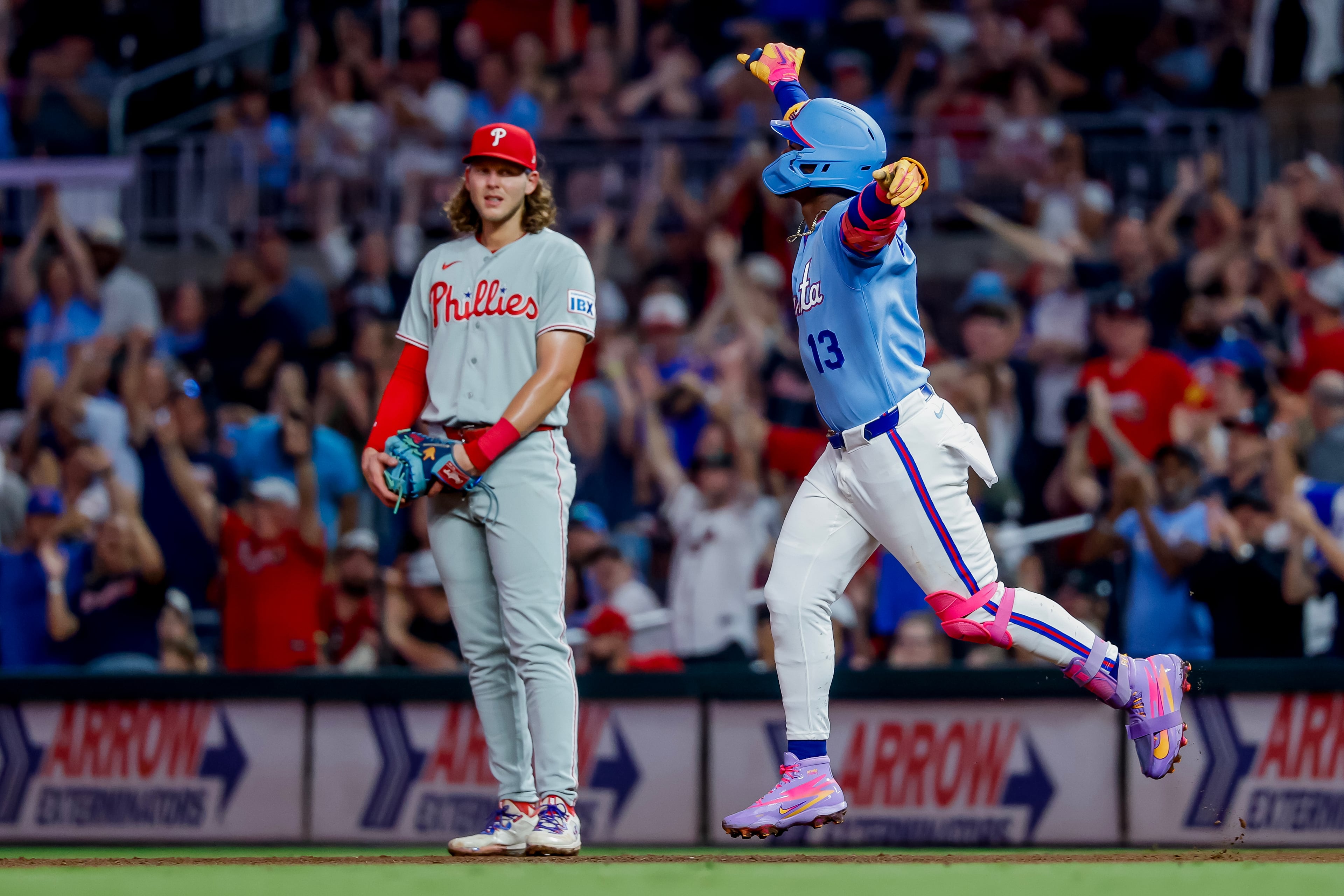 Ronald Acuna Jr. celebrates a home run earlier this month. Philly's Alec Bohm seems unimpressed. (Erik S. Lesser/AP)