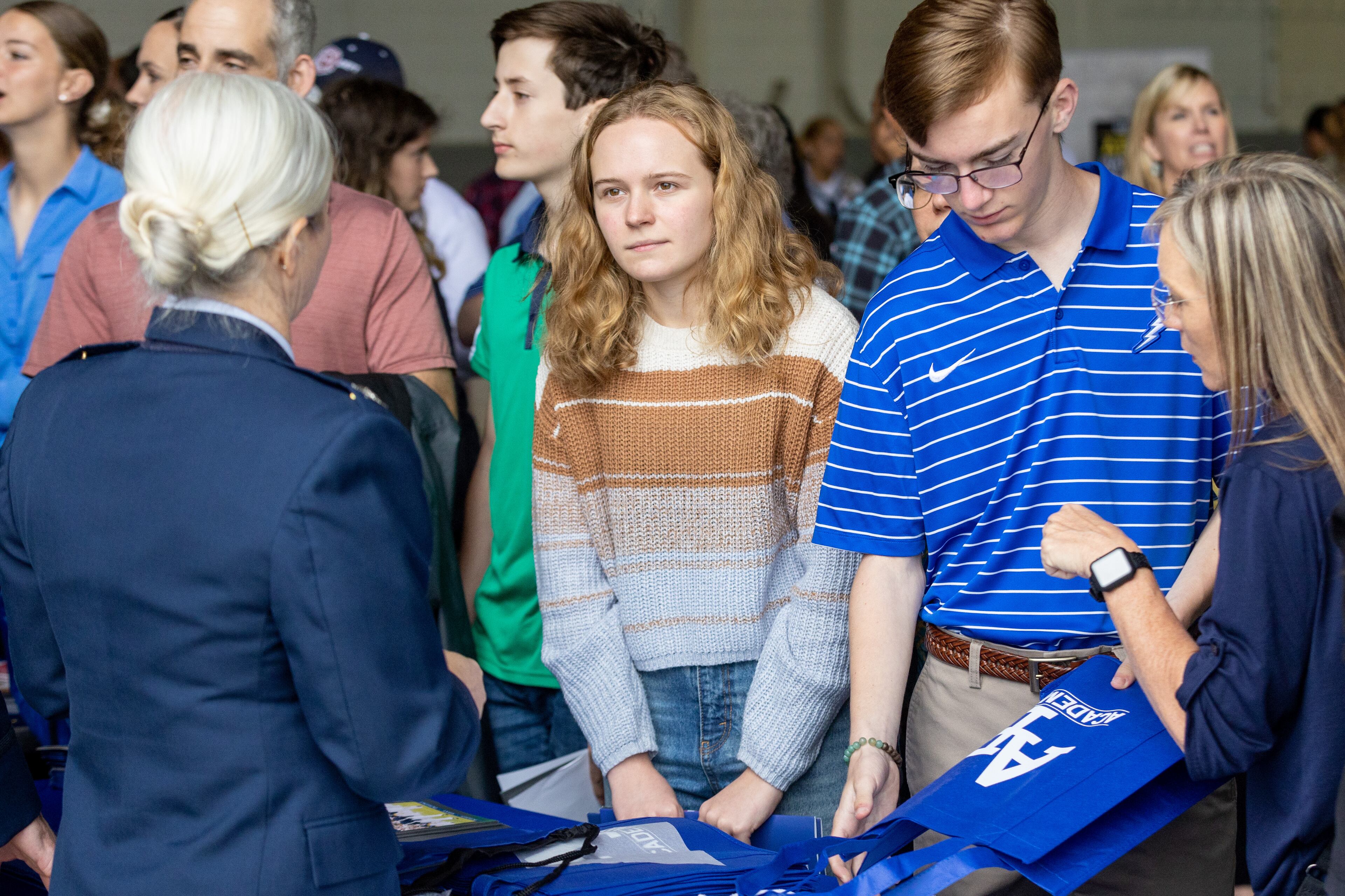 Sydney Watson (Center) talks with the Air Force Academy recruiters during the Military Service Academy Day at Dobbins Air Reserve Base in Marietta on Saturday, April 22, 2023. (Steve Schaefer/steve.schaefer@ajc.com)
