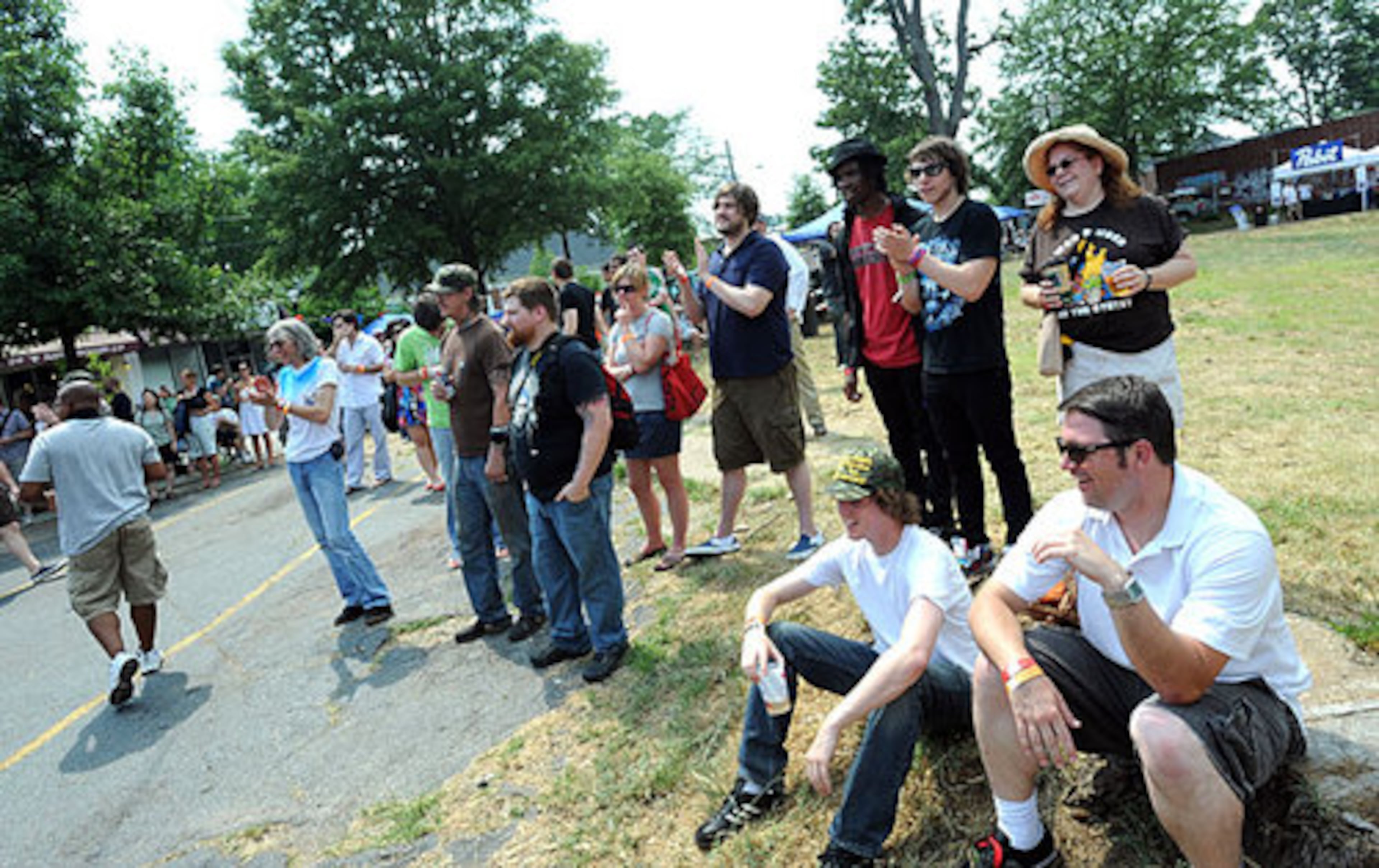 Festival-goers enjoy listening the music of The Electric Cycles during the music festival Saturday afternoon.