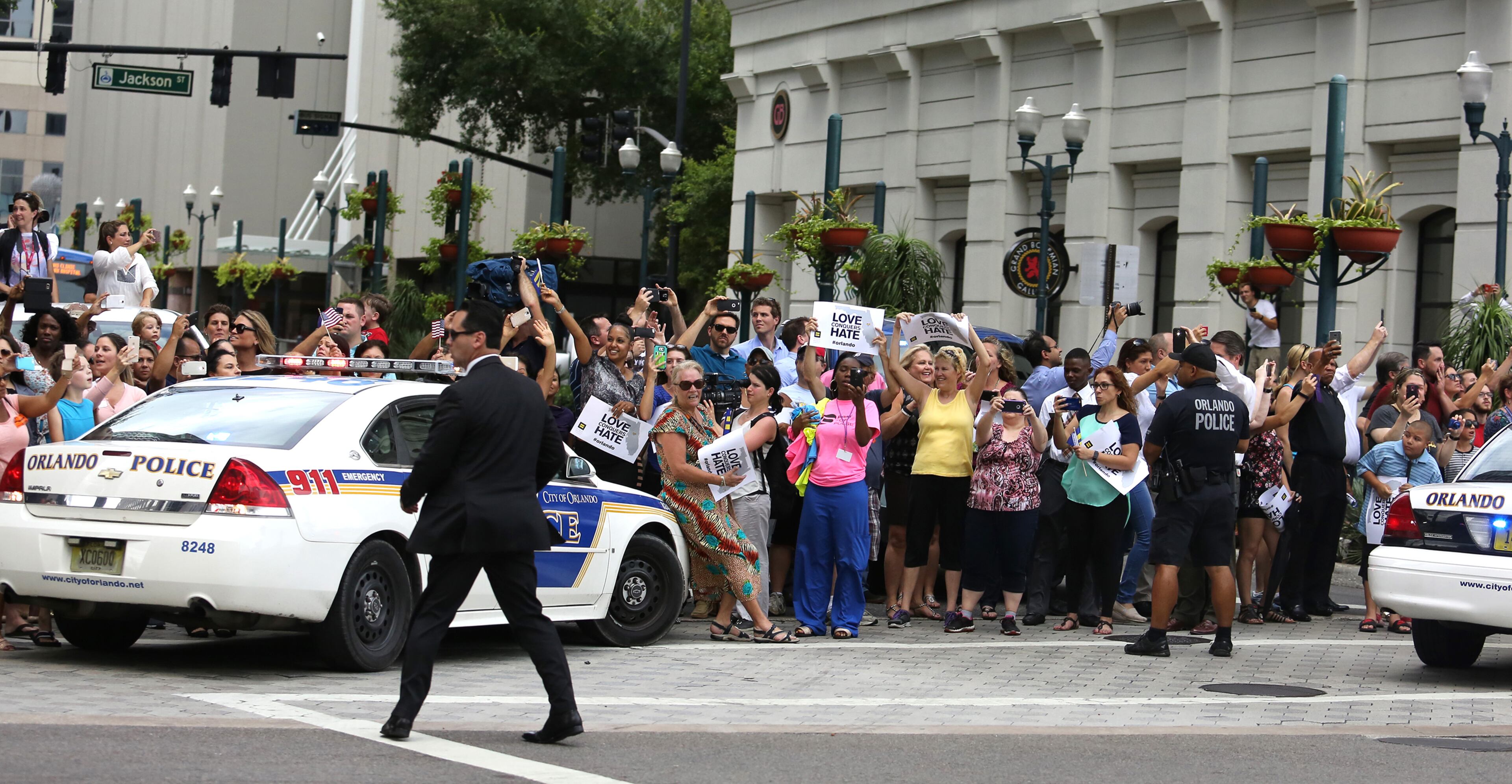Law enforcement provides crowd control on Orange Avenue as President Obama's motorcade arrives at the makeshift memorial for Pulse nightclub shooting victims at Dr. Phillips Center for the Performing Arts in Orlando, Fla., on Thursday, June 16, 2016. (Joe Burbank/Orlando Sentinel/TNS)