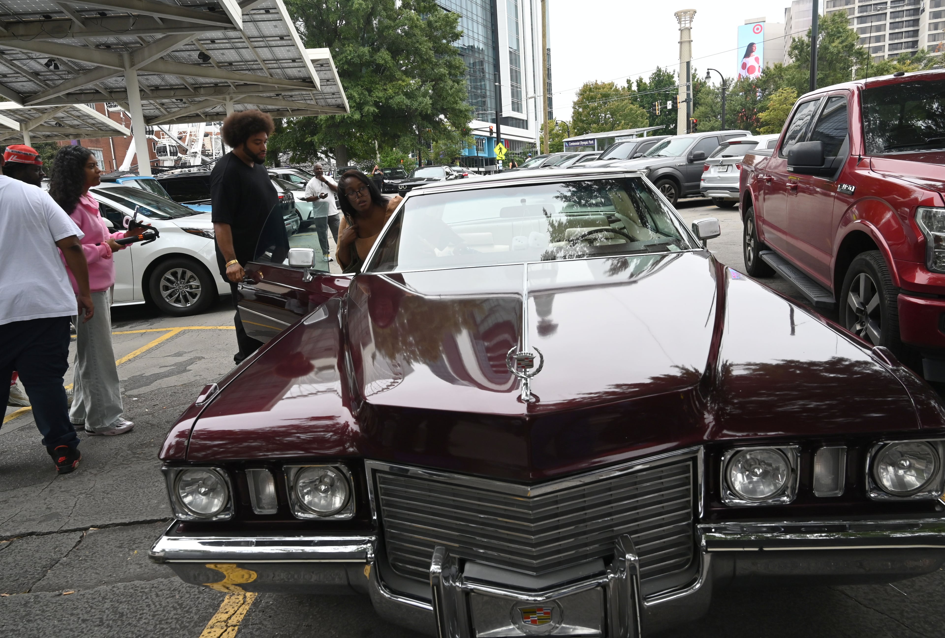 Melanie and John Williams leave in their Cadillac after purchasing limited-edition apparel and accessories from the Outkast and Waffle House collaboration during an exclusive launch event at the Centennial Olympic Park Waffle House on Friday, Oct. 2, 2026, in Atlanta. Outkast and Waffle House launched a limited-edition apparel and accessories collection celebrating Atlanta’s music and diner culture, highlighted by a pop-up event at the Centennial Olympic Park Waffle House. (Hyosub Shin/AJC)