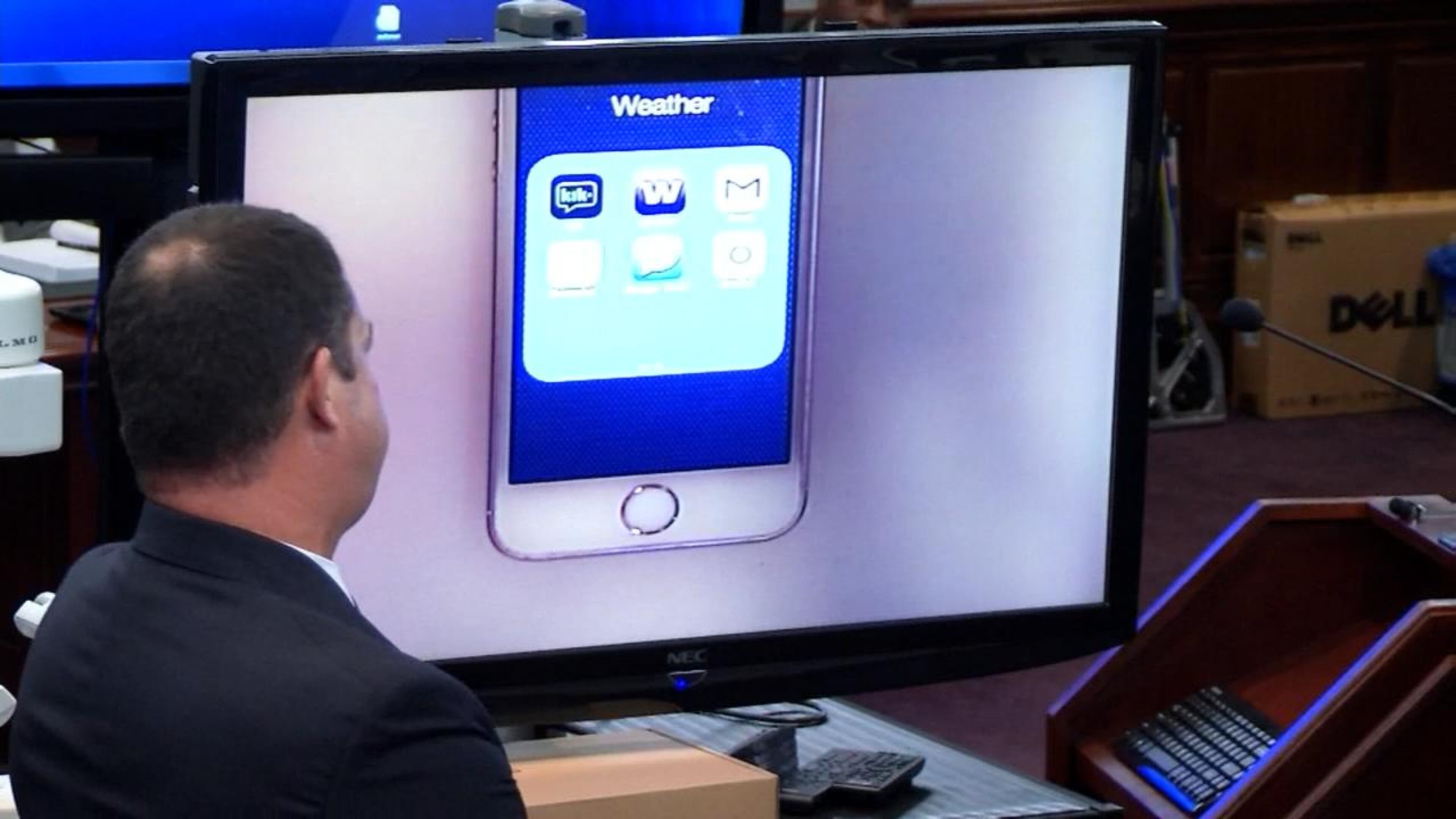 Cobb County lead detective Phil Stoddard shows to the jury an image from Justin Ross Harris' phone during Harris' murder trial at the Glynn County Courthouse in Brunswick, Ga., on Tuesday, Oct. 25, 2016. The phone shows a folder called "Weather" that contains online chat apps, which the prosecution says is an effort to hide apps. (screen capture via WSB-TV)