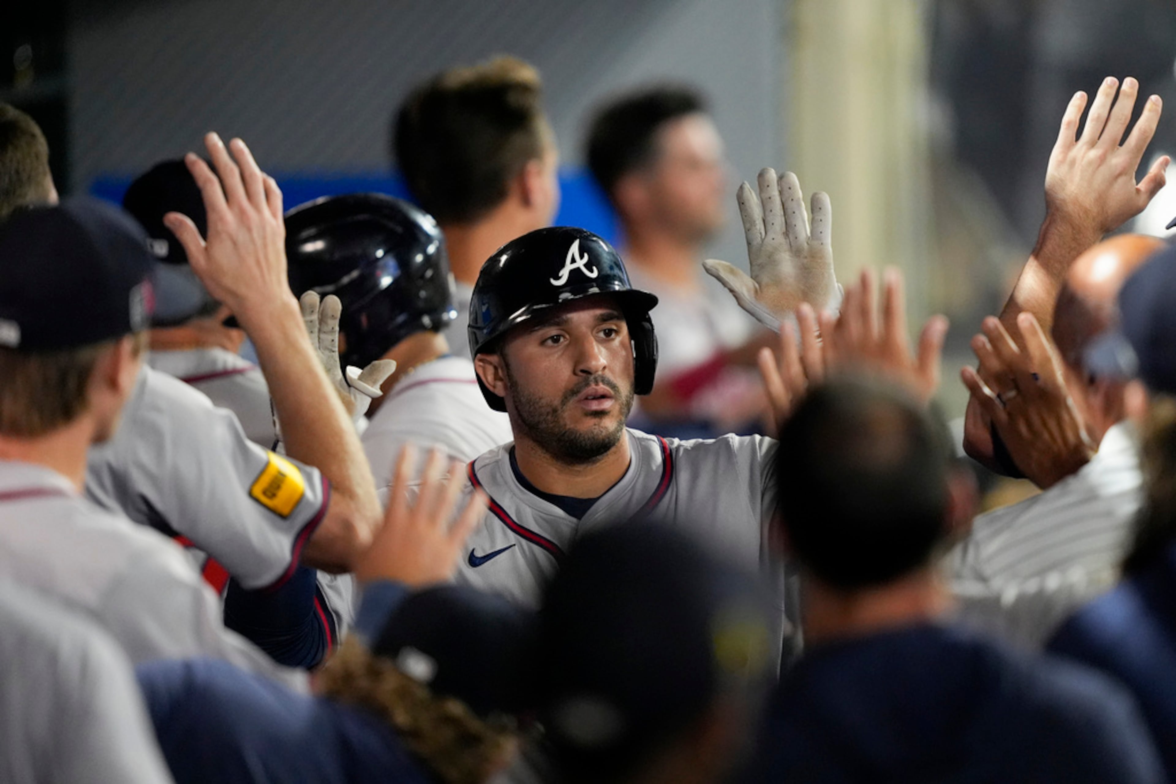 Atlanta Braves' Ramon Laureano, center, celebrates with teammates in the dugout after hitting a two-run home run during the fifth inning of a baseball game against the Los Angeles Angels, Saturday, Aug. 17, 2024, in Anaheim, Calif. (AP Photo/Ryan Sun)