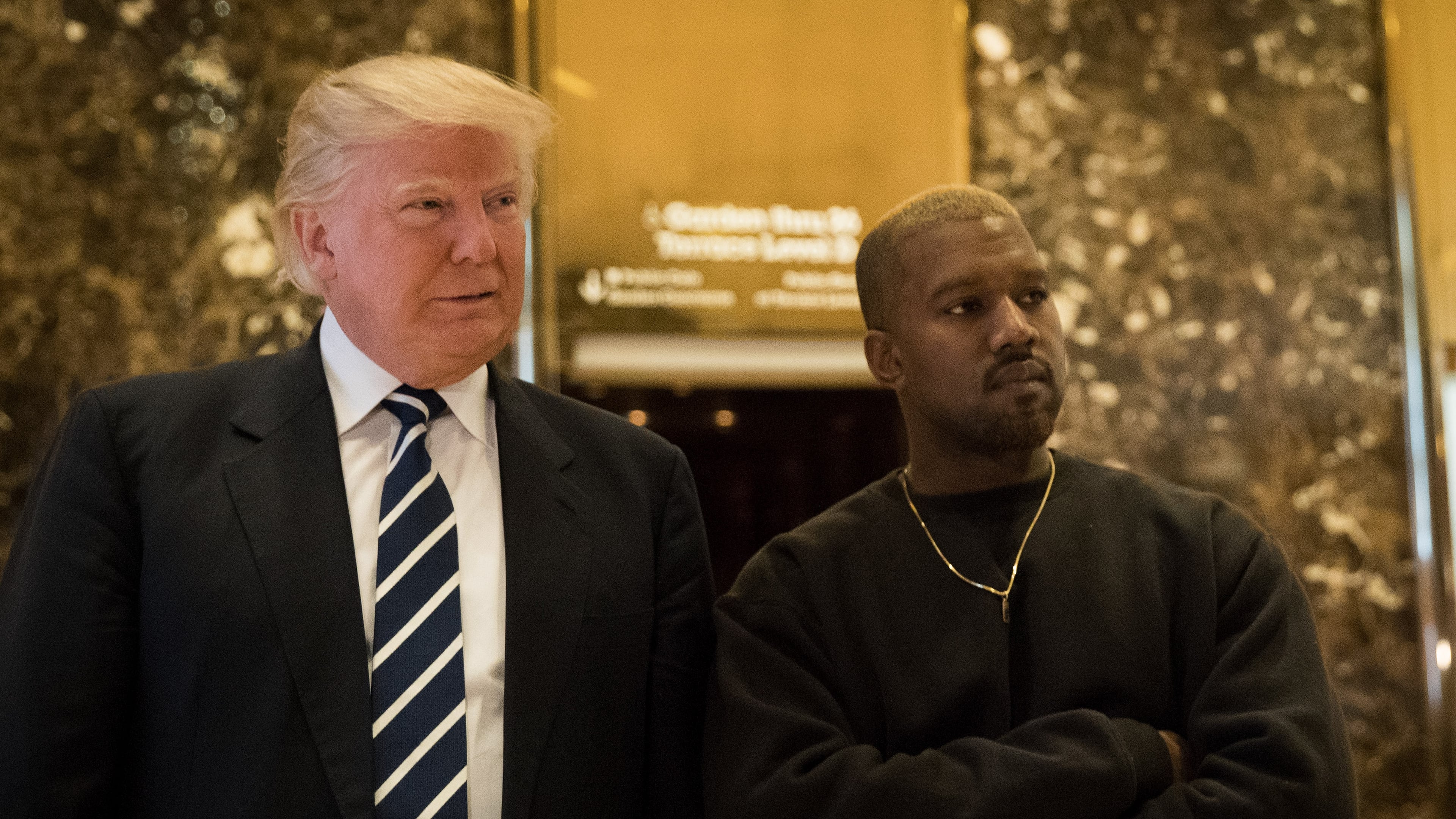 NEW YORK, NY - DECEMBER 13: (L to R) President-elect Donald Trump and Kanye West stand together in the lobby at Trump Tower, December 13, 2016 in New York City. President-elect Donald Trump and his transition team are in the process of filling cabinet and other high level positions for the new administration. (Photo by Drew Angerer/Getty Images)