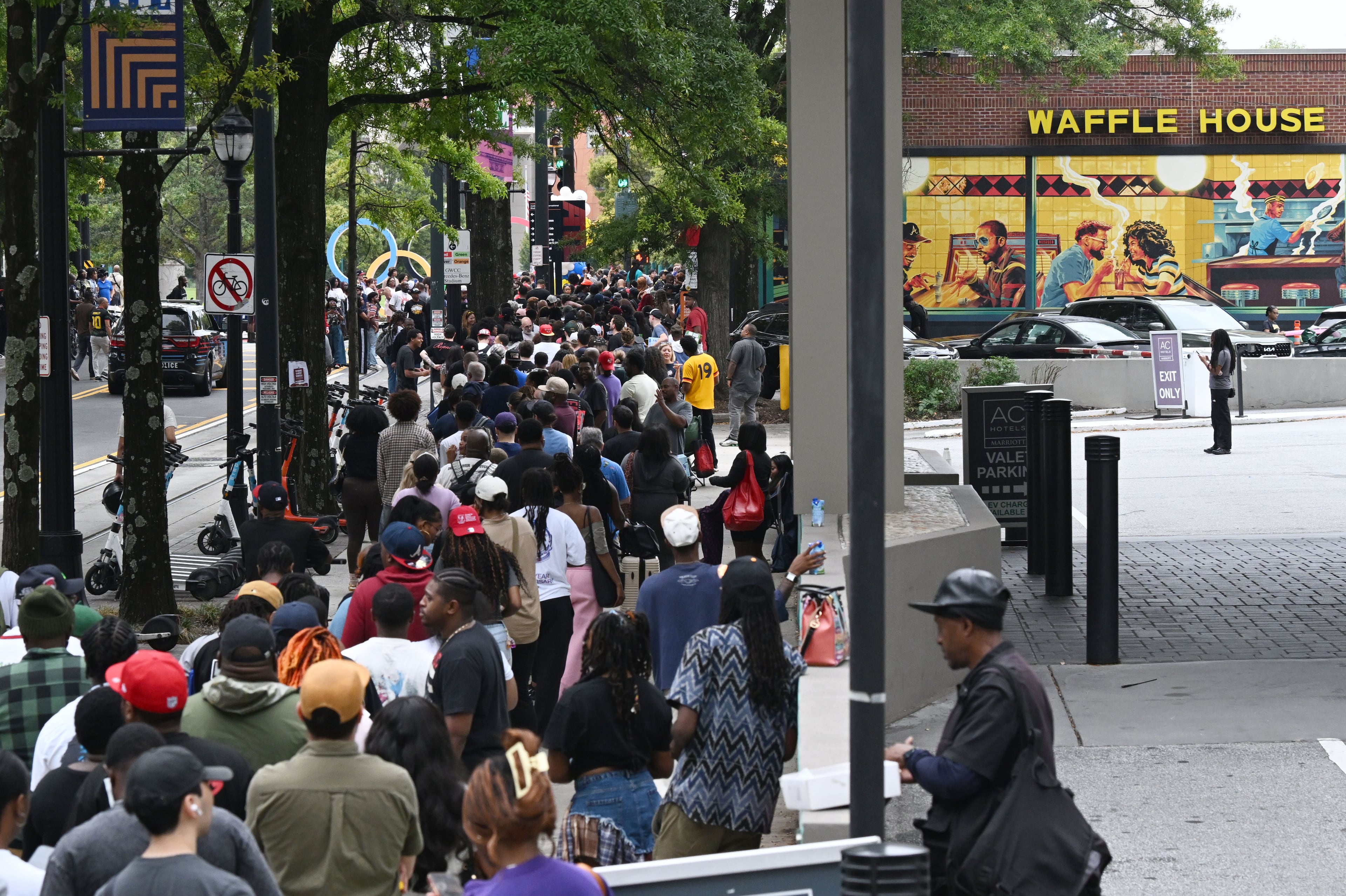 People wait in a long line to purchase limited-edition apparel and accessories from the Outkast and Waffle House collaboration. (Hyosub Shin/AJC)