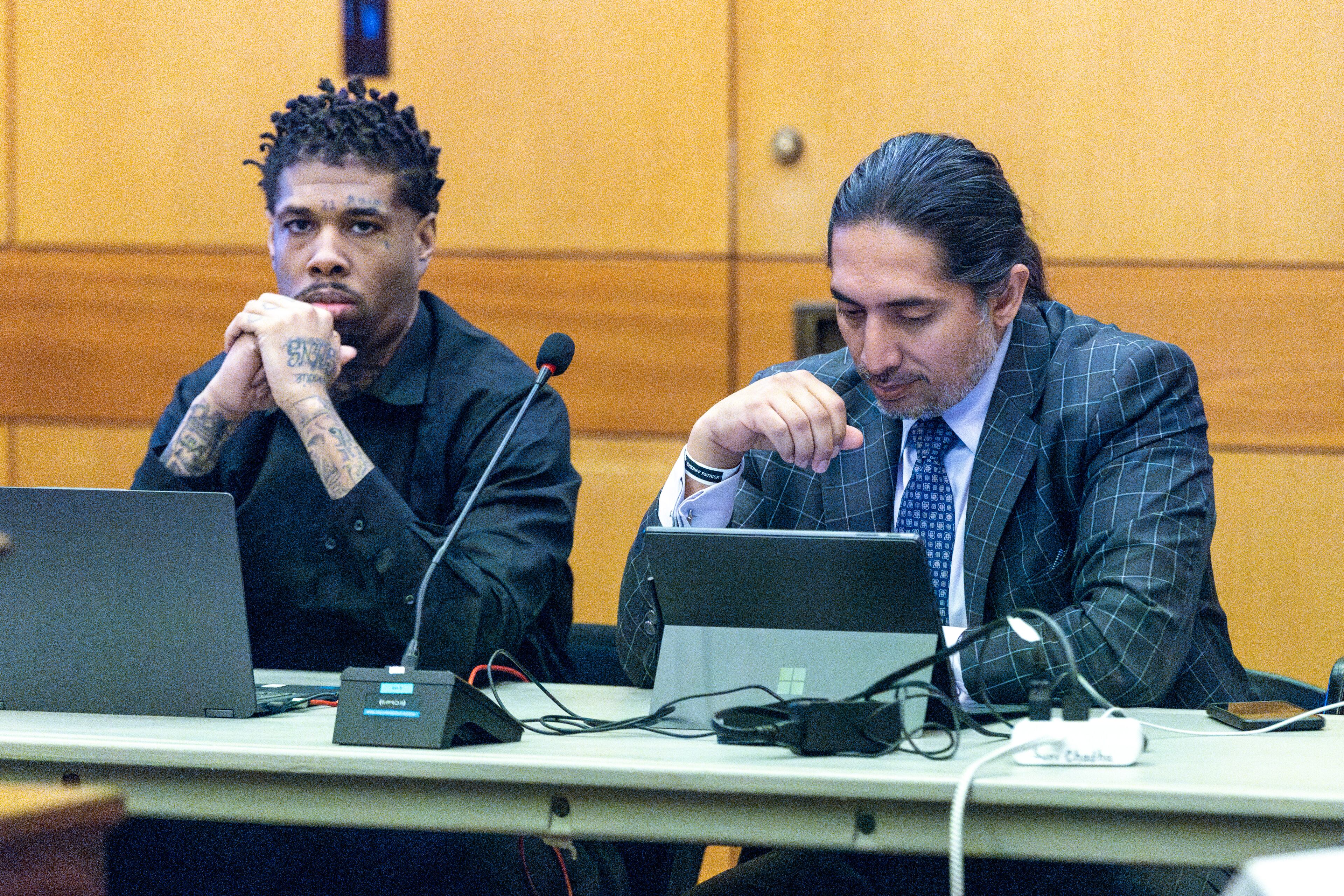 Cordarius Dorsey (left) sits alongside attorney Suri Chadha Jimenez during jury selection in the “Young Slime Life” gang case at the Fulton County Courthouse Tuesday, September 12, 2023. (Steve Schaefer/steve.schaefer@ajc.com)