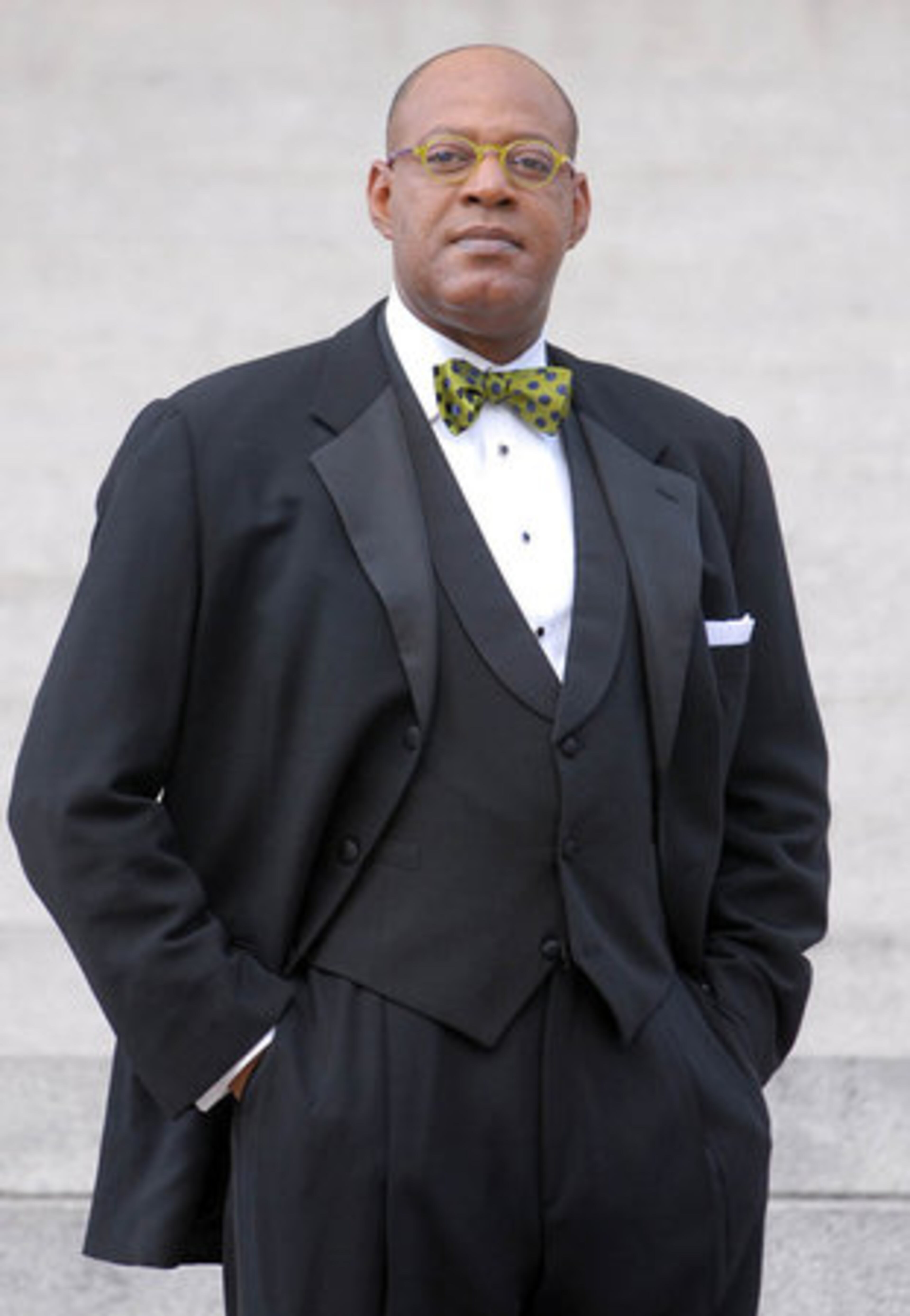 Scarborough is wearing "a rarefied mix of the classic and casual; an Italian-made classic tuxedo updated with lime-green bow tie and matching formal scarf."