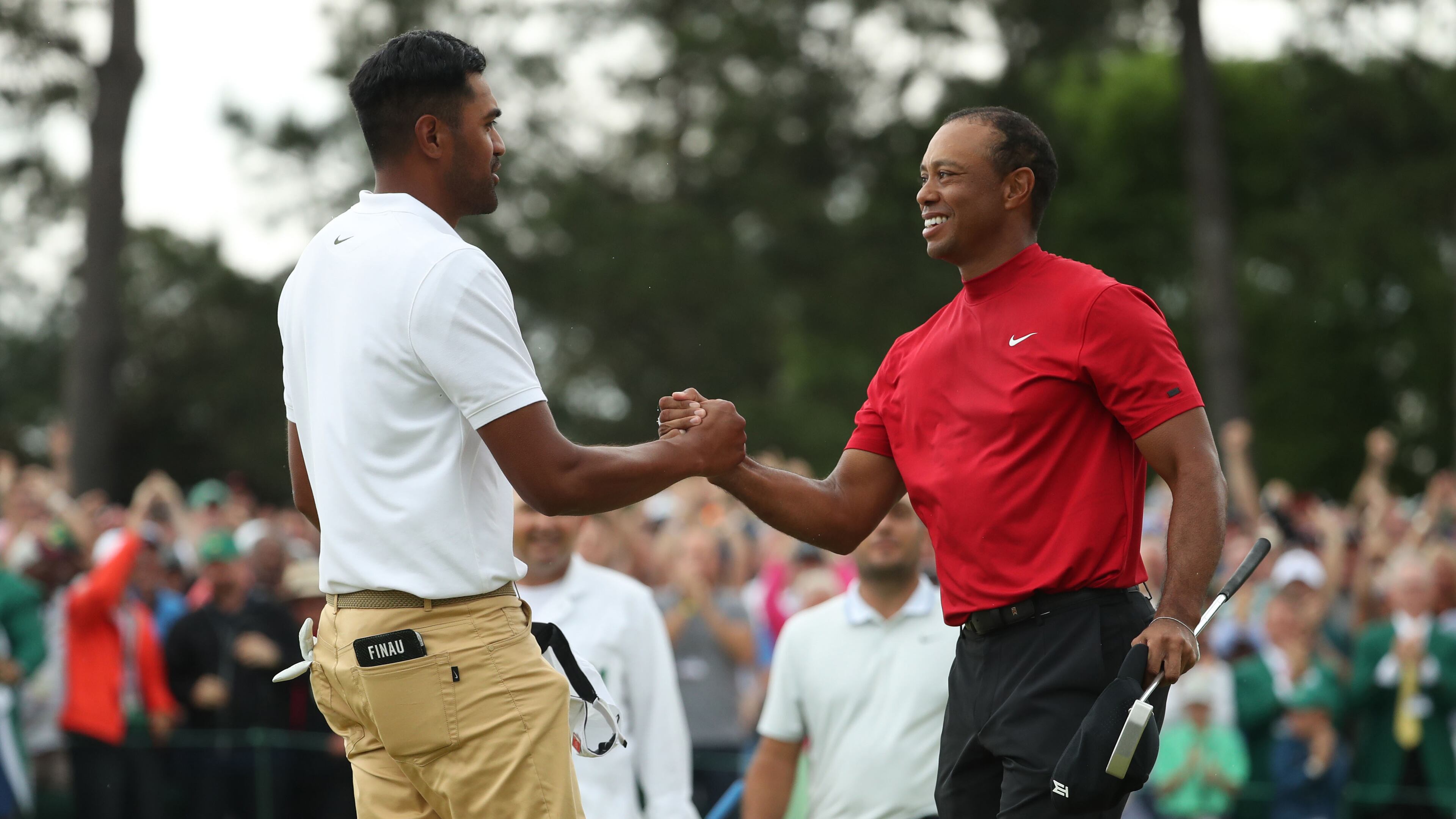 Tiger Woods shakes hands with Tony Finau after winning the Masters Sunday, April 14, 2019, at Augusta National Golf Club in Augusta. (JASON GETZ/SPECIAL TO THE AJC)