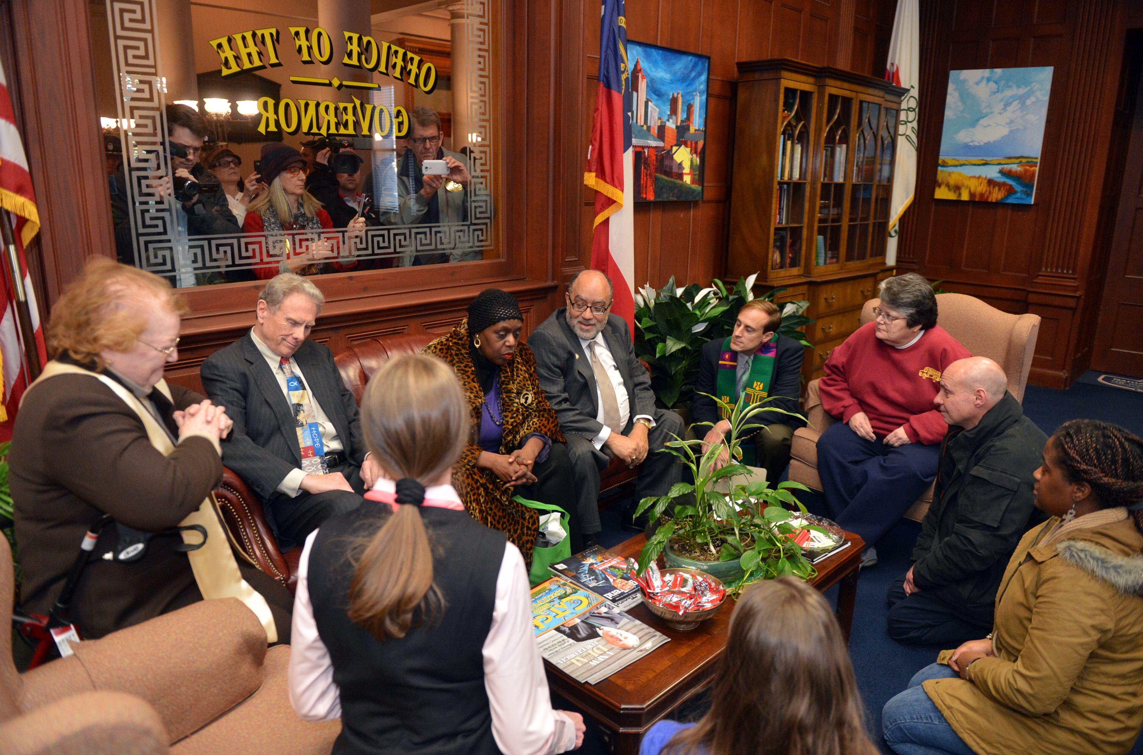 Protesters sit in the Governors office awaiting arrest. T KENT D JOHNSON/KDJOHNSON@AJC.COM