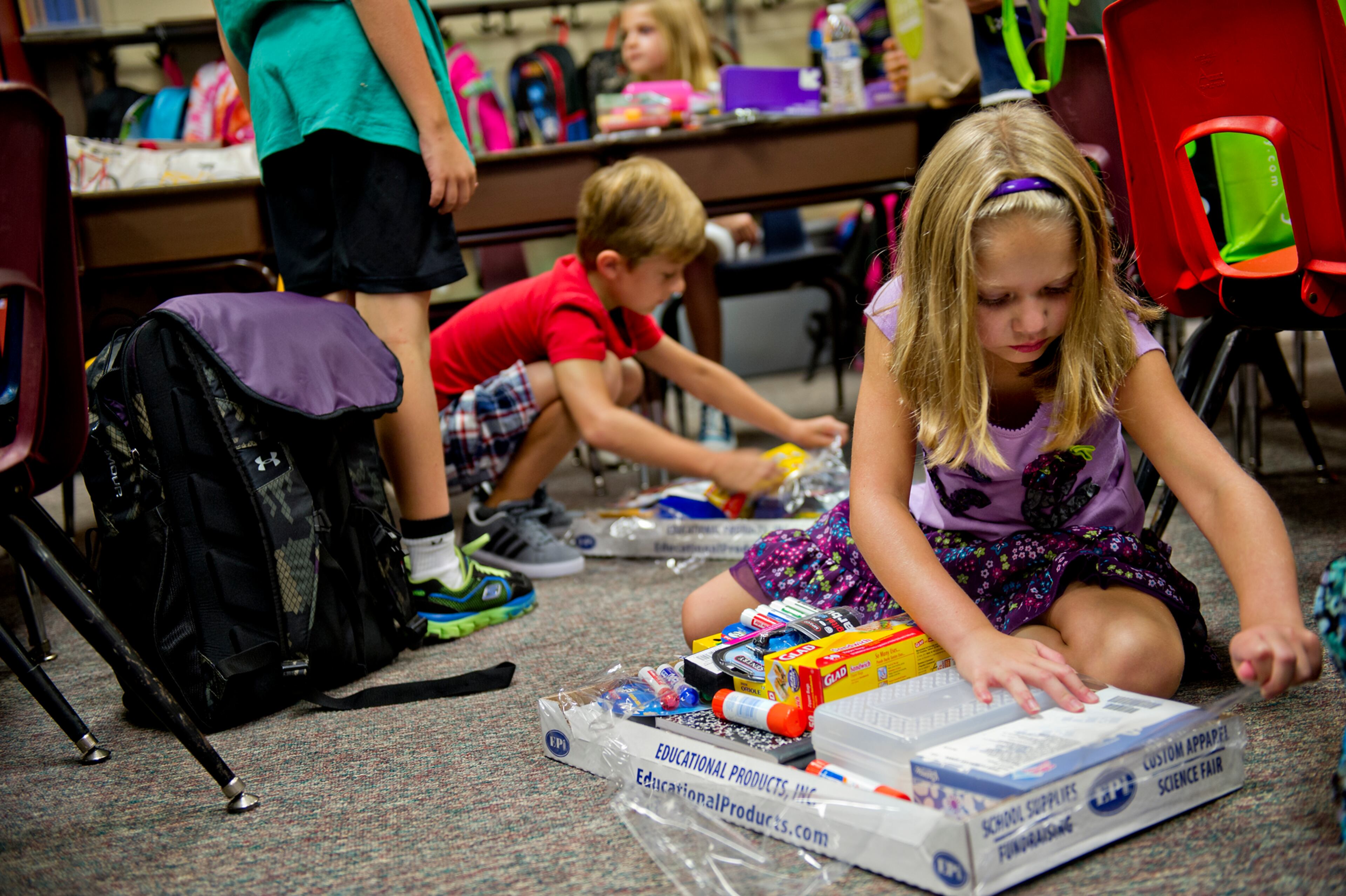 Kaylah Hester (right) and Tyler Crump open their supplies during the first day of classes at Davis Elementary School in Marietta on Monday, August 4, 2014. Teachers and administrators at the school dressed as pirates for the first day of school. Students in Cobb County and Atlanta public schools headed back to class on Monday for the new school year. JONATHAN PHILLIPS / SPECIAL
