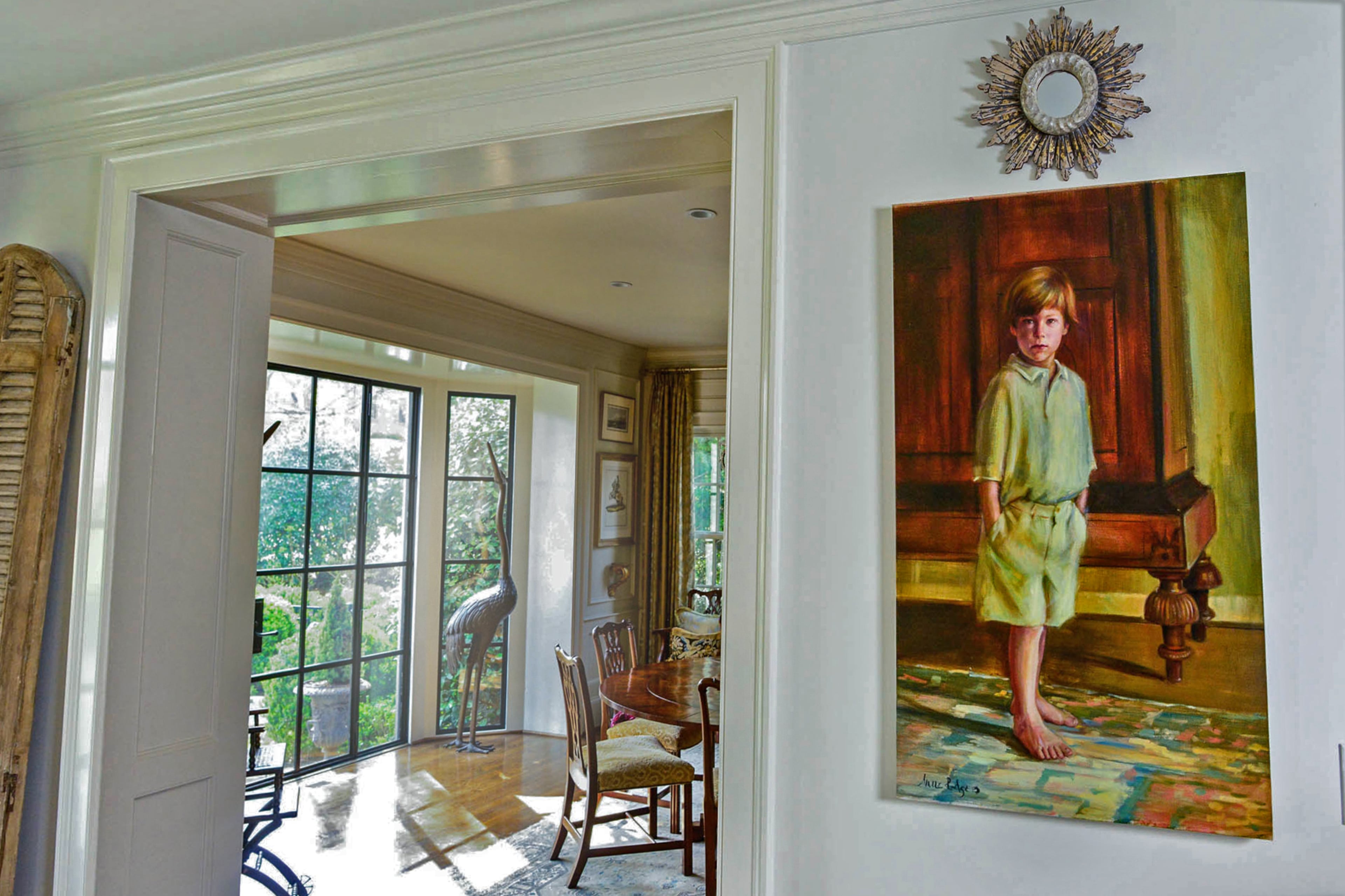 An oil painting by Ann Rogers features her son, Wood Adamson, when he was a child.