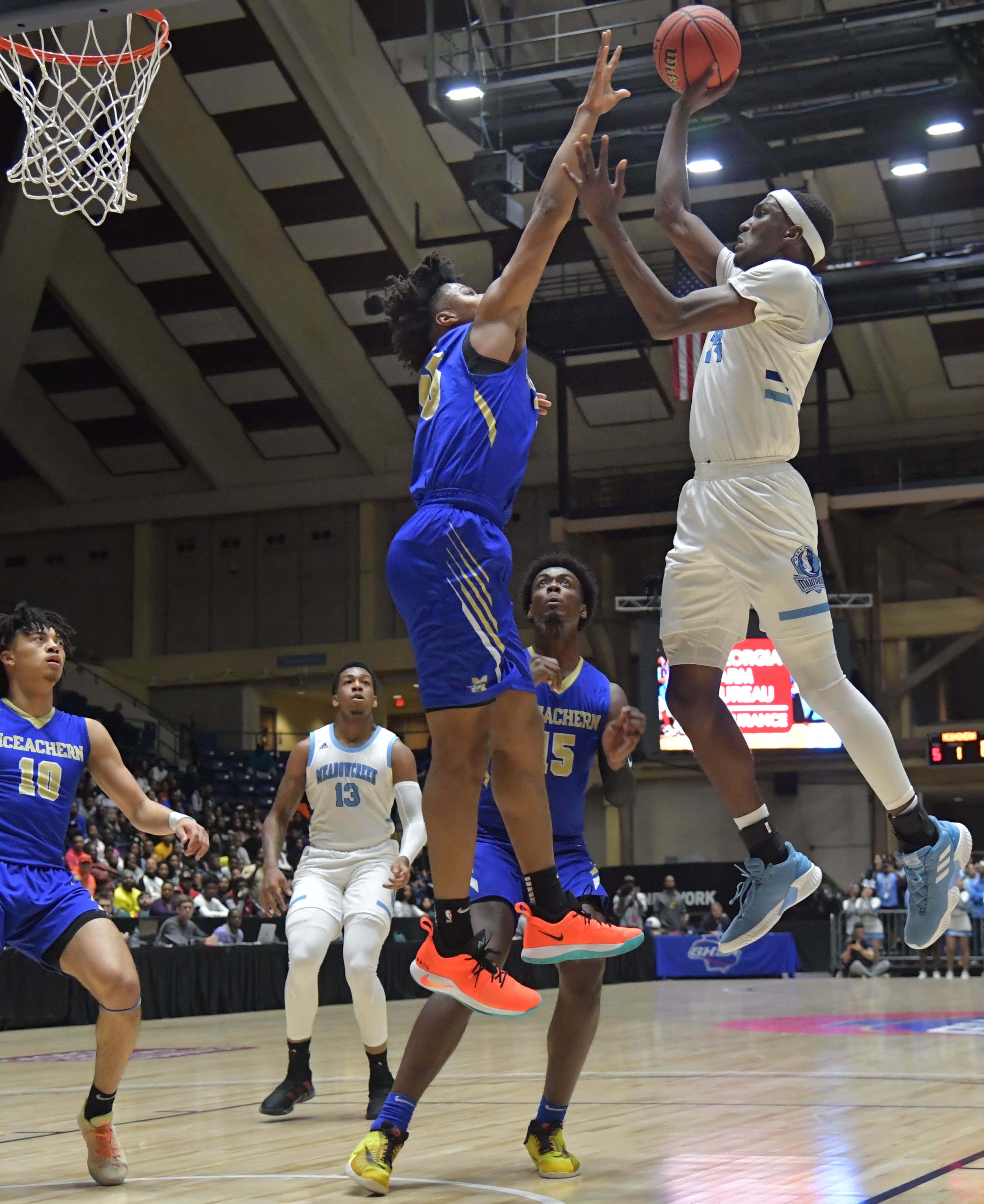 March 9, 2019 Macon - Meadowcreek Jamir Chaplin (24) gets off a shot over McEachern Isaac Okoro (35) in GHSA State Basketball Championship game at the Macon Centreplex in Macon on Saturday, March 9, 2019. HYOSUB SHIN / HSHIN@AJC.COM