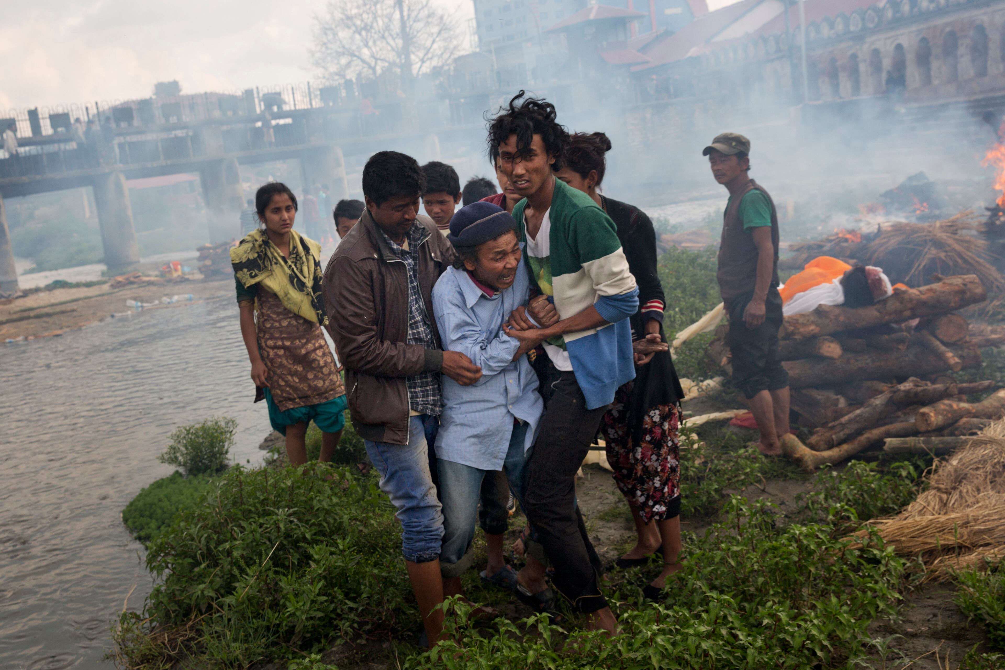 A Hindu man breaks down during a funeral of Saturday�s earthquake victims on the Pashupatinath bank of Bagmati river, in Kathmandu, Nepal, Sunday, April 26, 2015. The earthquake centered outside Kathmandu, the capital, was the worst to hit the South Asian nation in over 80 years. It destroyed swaths of the oldest neighborhoods of Kathmandu, and was strong enough to be felt all across parts of India, Bangladesh, China's region of Tibet and Pakistan.(AP Photo/Bernat Armangue)