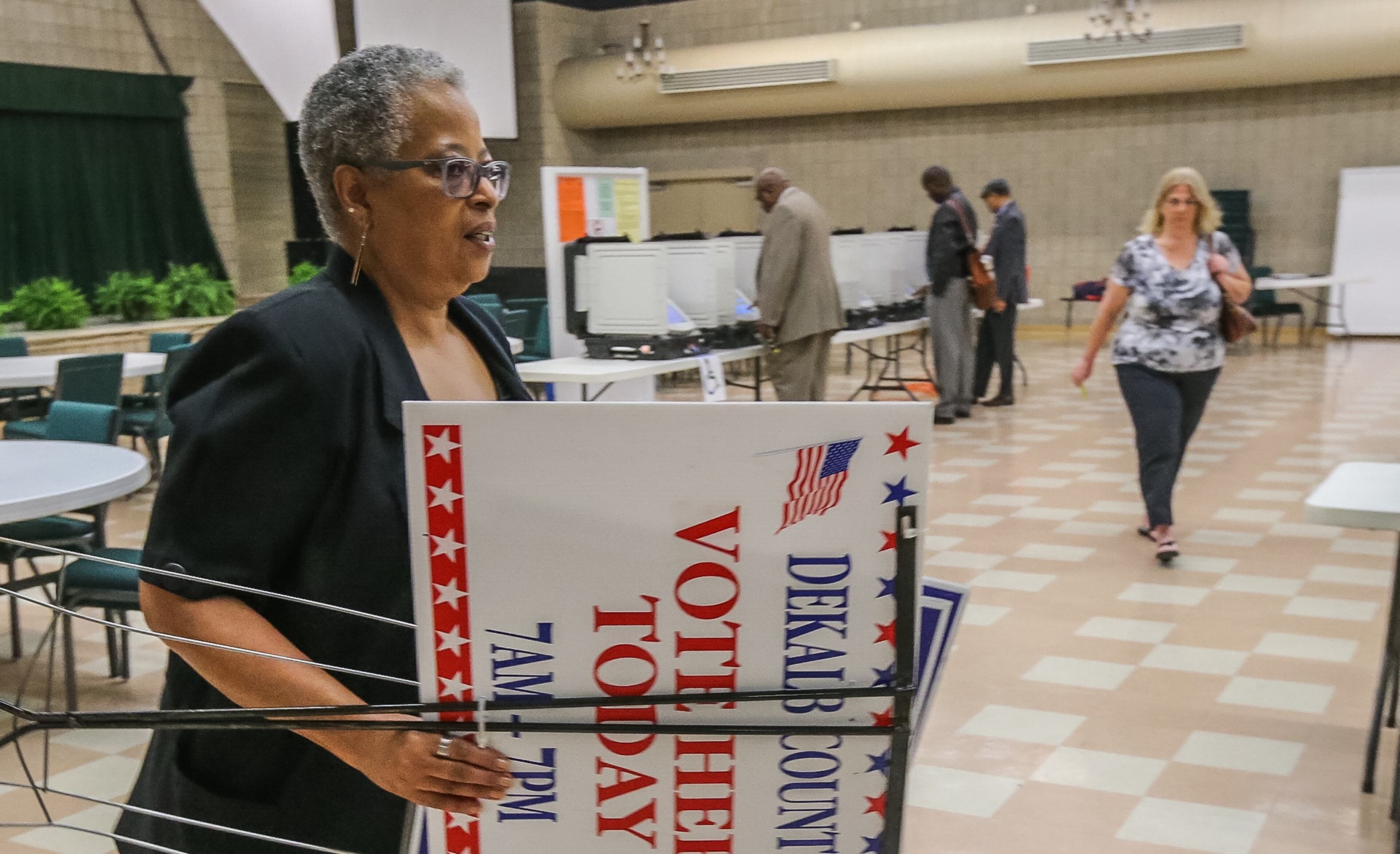 Poll manager Rosalind Smith sets up at Mt. Carmel polling place in DeKalb on Tuesday, May 24, 2016, for the primaries.