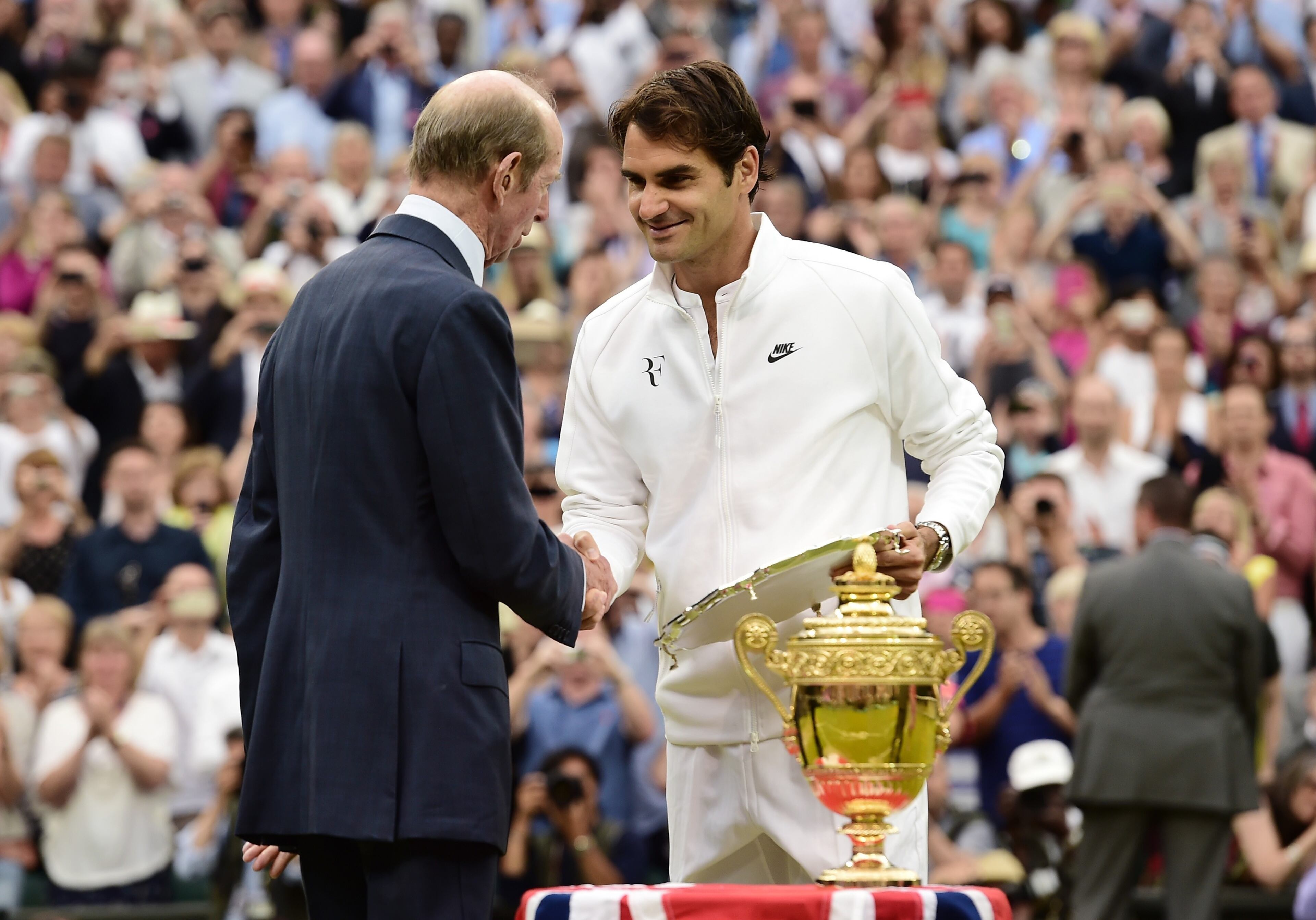LONDON, ENGLAND - JULY 12: Roger Federer of Switzerland is presented with the runners up trophy by Prince Edward, Duke of Kent after losing to Novak Djokovic of Serbia in the Final of the Gentlemen's Singles on day thirteen of the Wimbledon Lawn Tennis Championships at the All England Lawn Tennis and Croquet Club on July 12, 2015 in London, England. (Photo by Alex Broadway/Anadolu Agency/Getty Images)