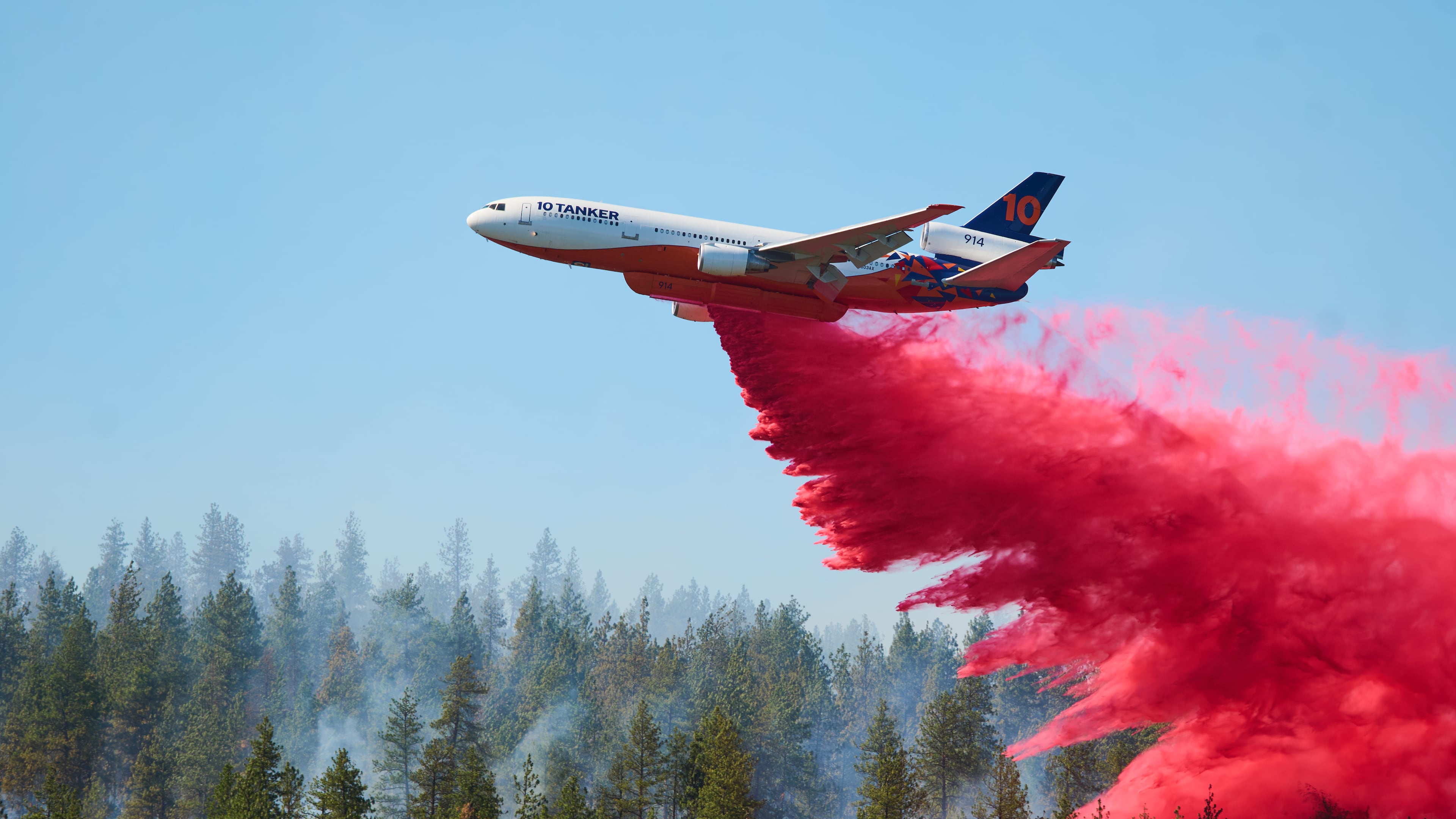 Fire retardant is dropped by air tanker onto the Upriver Fire on Tuesday, June 16, 2026 in Spokane, Wash. (Skyler Geissler via AP)