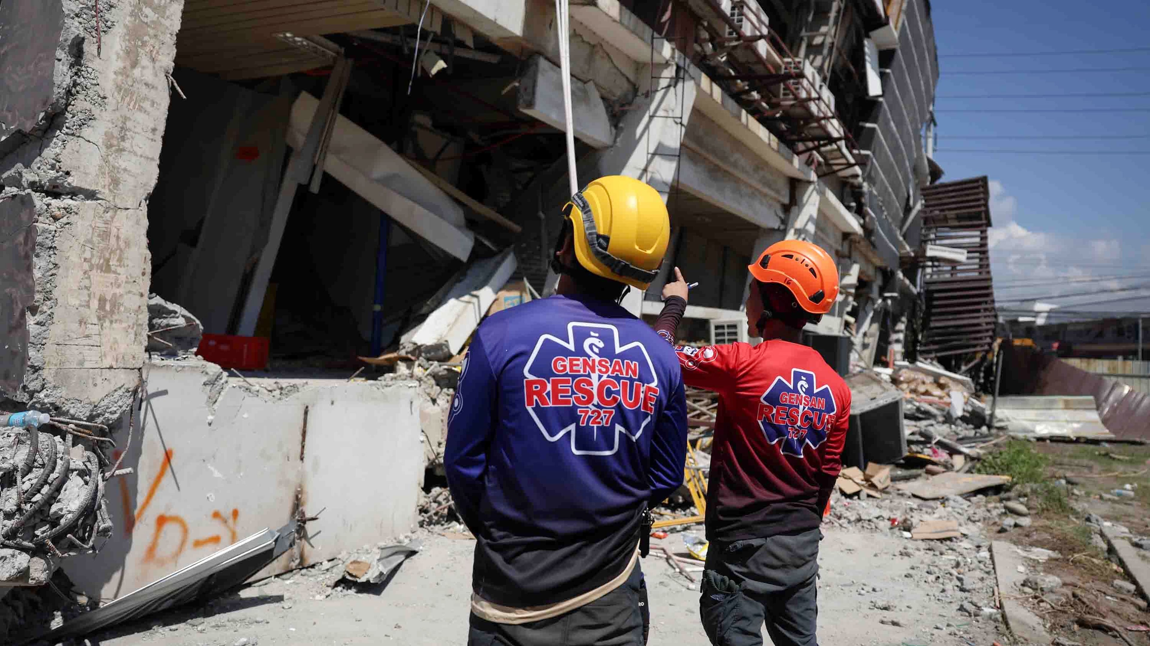 Rescuers inspect a damaged building following an earhtquake in General Santos, Philippines Tuesday, June 9, 2026. (AP Photo/Basilio Sepe)