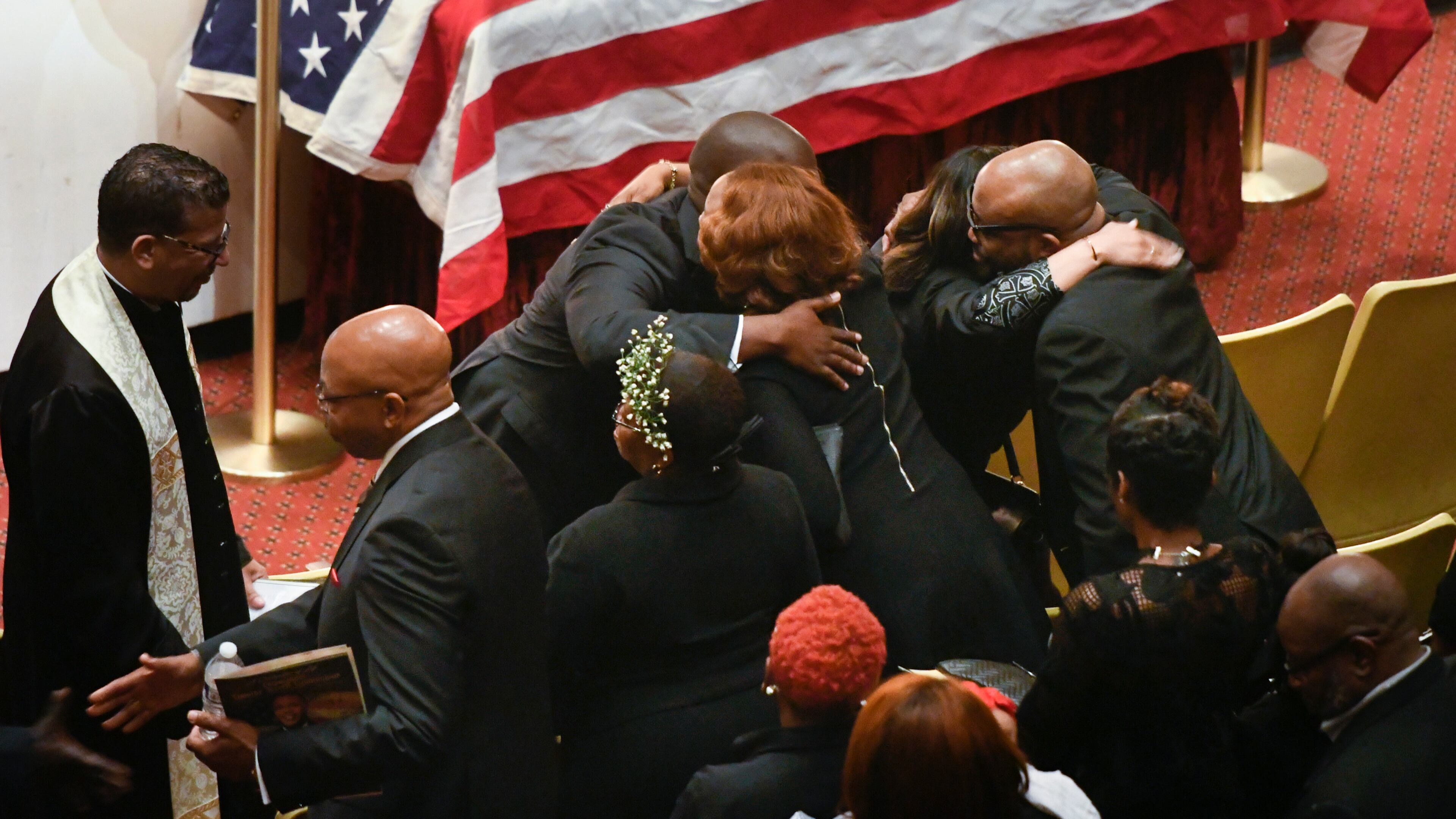 Family members are hugged by clergy during a memorial service for CDC researcher Timothy Cunningham, who was pulled from the Chattahoochee River after being missing for seven weeks, held Saturday at Morehouse April 21, 2018.