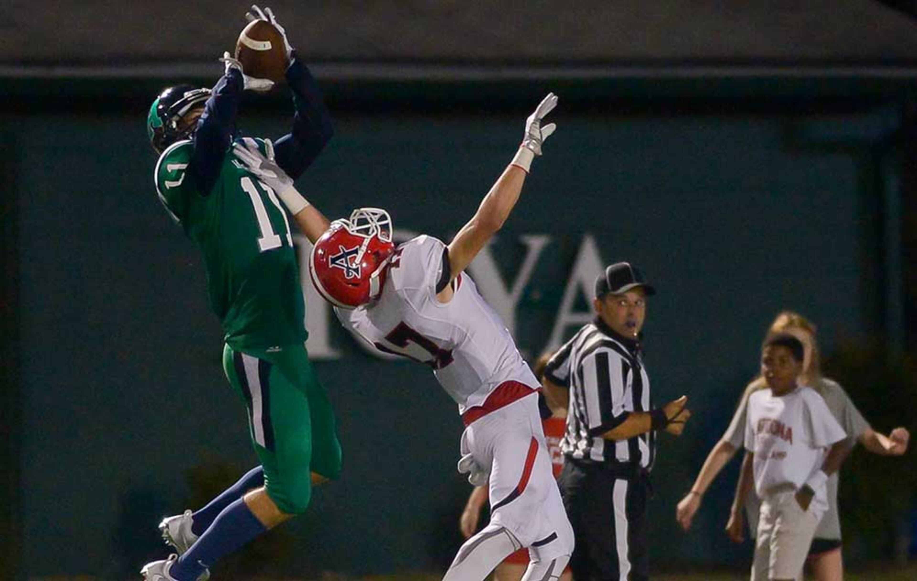 Harrison's Steven Peterson (11) makes a catch over Allatoona junior QB Cameron Carter (17) and scores a touchdown in the second half of Friday's game.