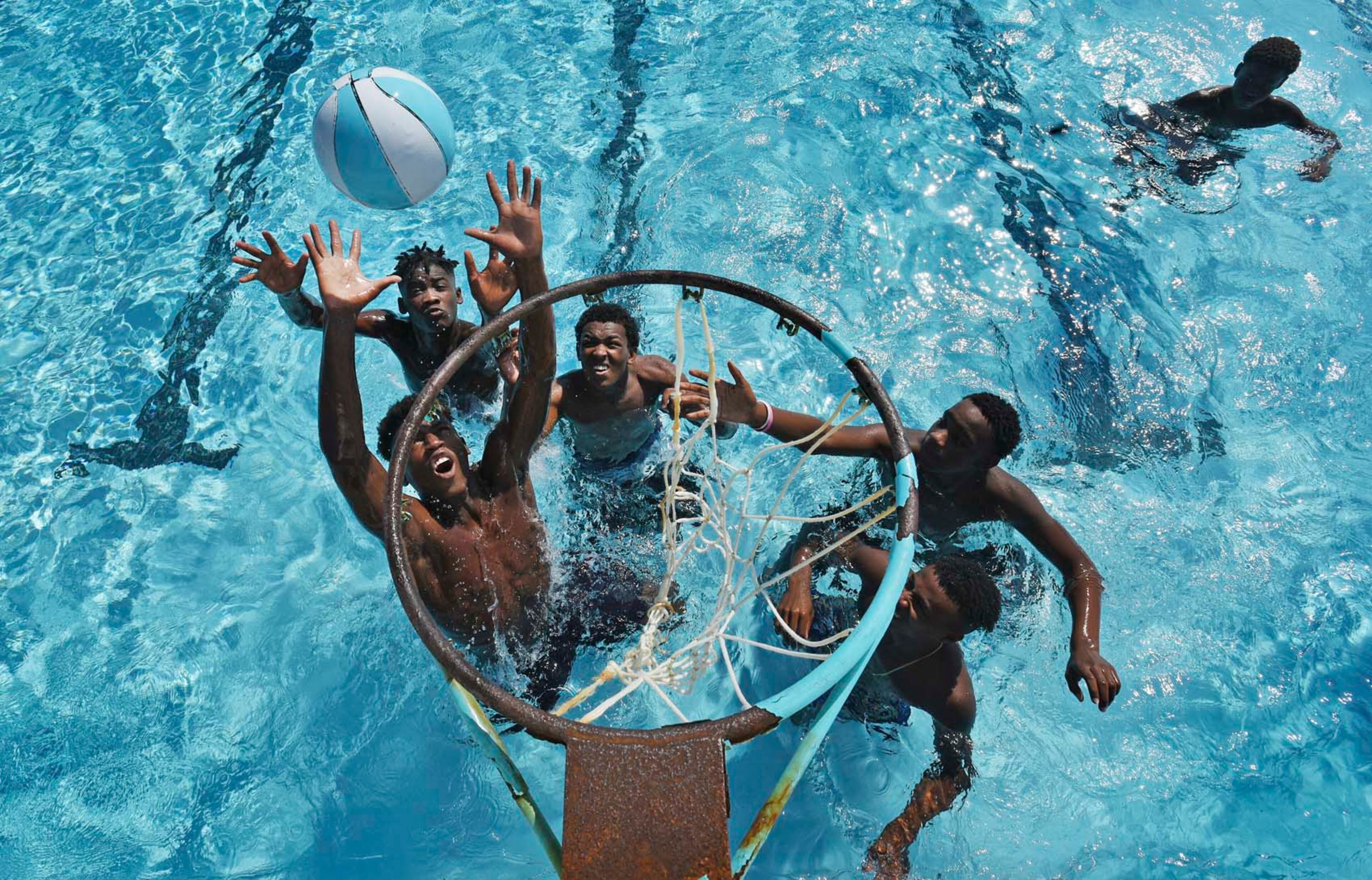 Swimmers at the Clanzel T. Brown pool in Jacksonville, Fla., take part in an aquatic pickup game of basketball as they beat the summer heat Wednesday, July 19, 2017. (Bob Self/The Florida Times-Union via AP)
