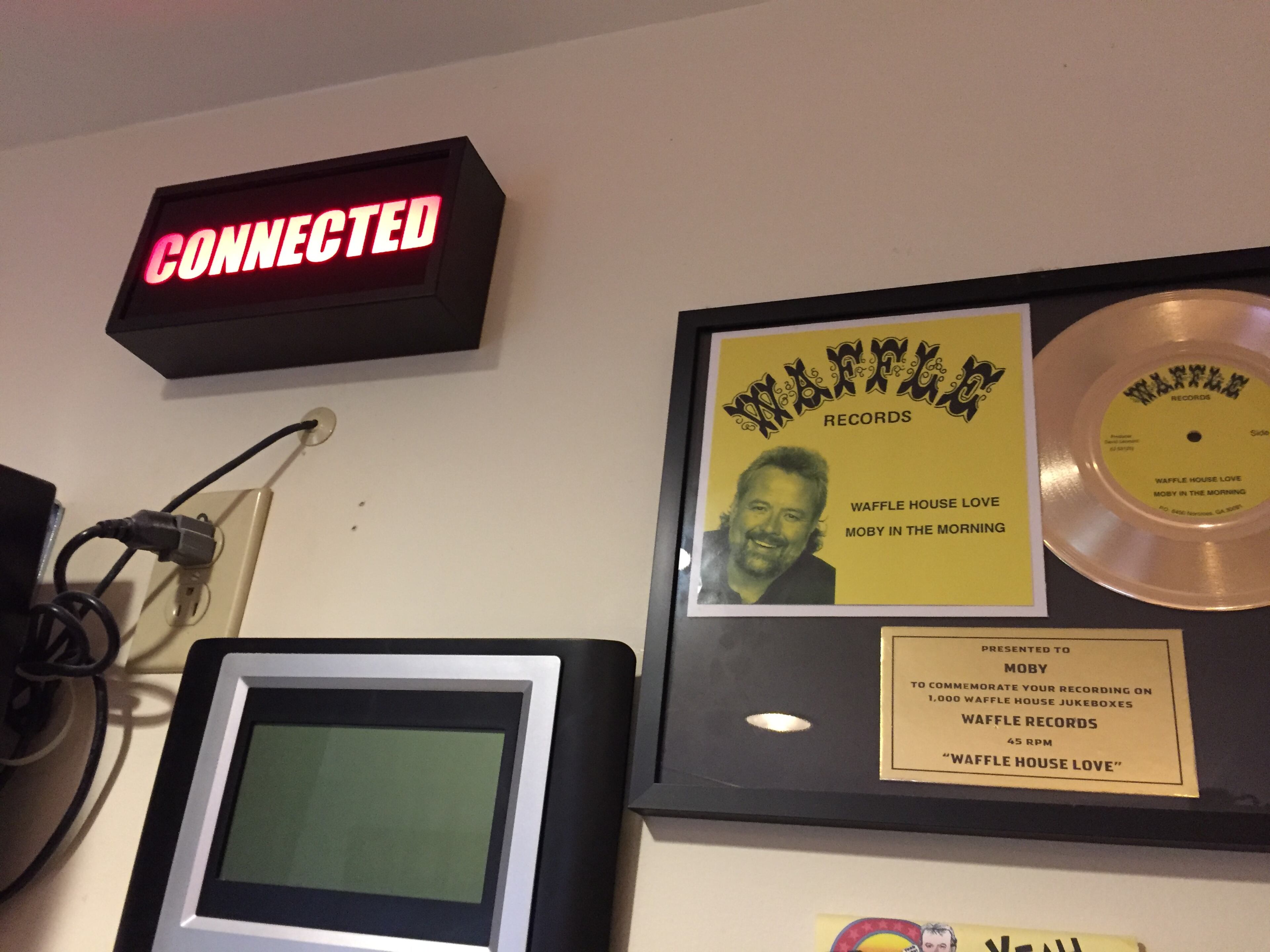 The "Connected" light on the wall of Moby in the Morning studios, along with one of Moby's songs. CREDIT: Rodney Ho/ rho@ajc.com